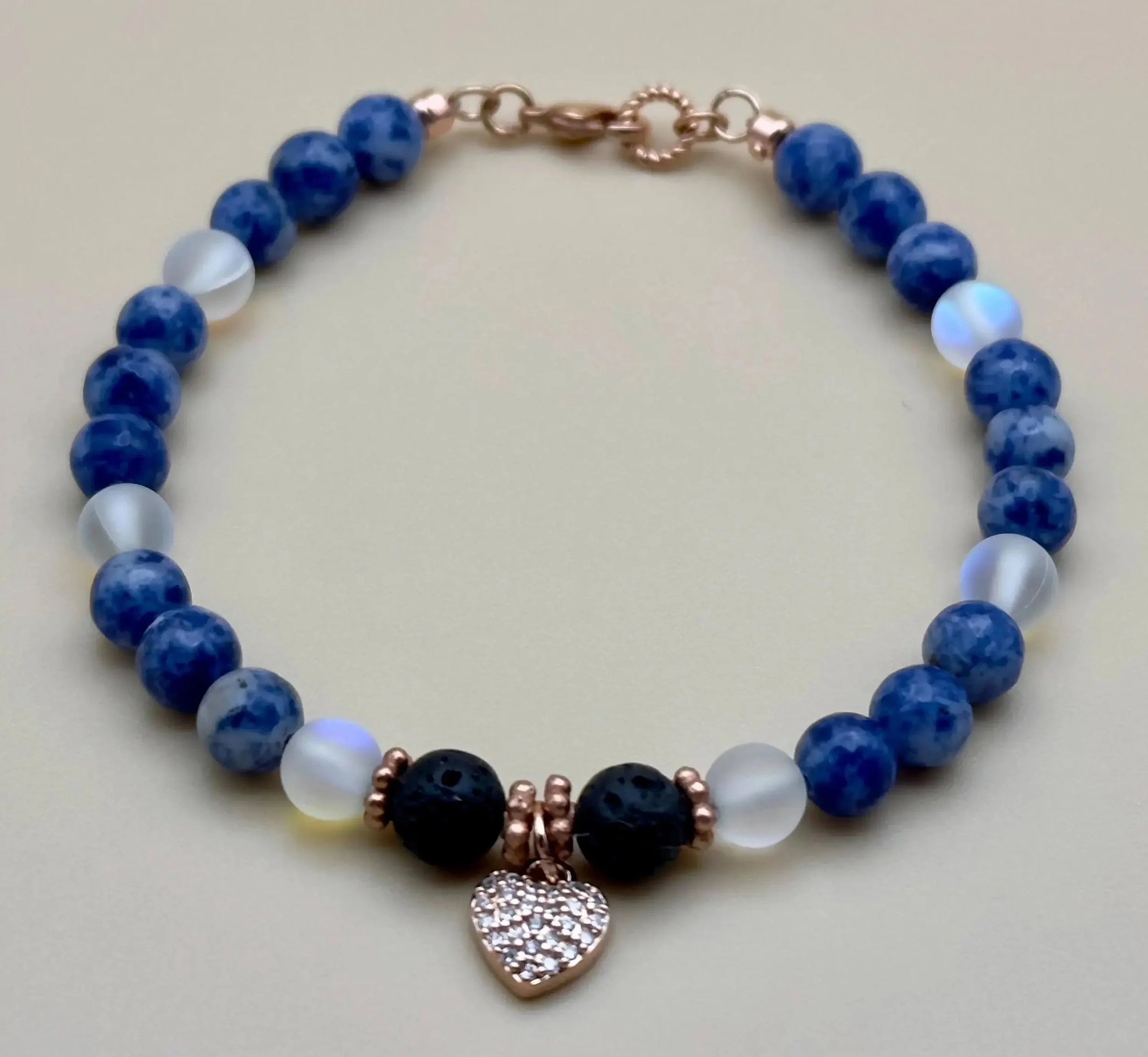 a dainty and premium gold-filled jewelry piece featuring a hand-selected cluster of translucent and iridescent blue stones.