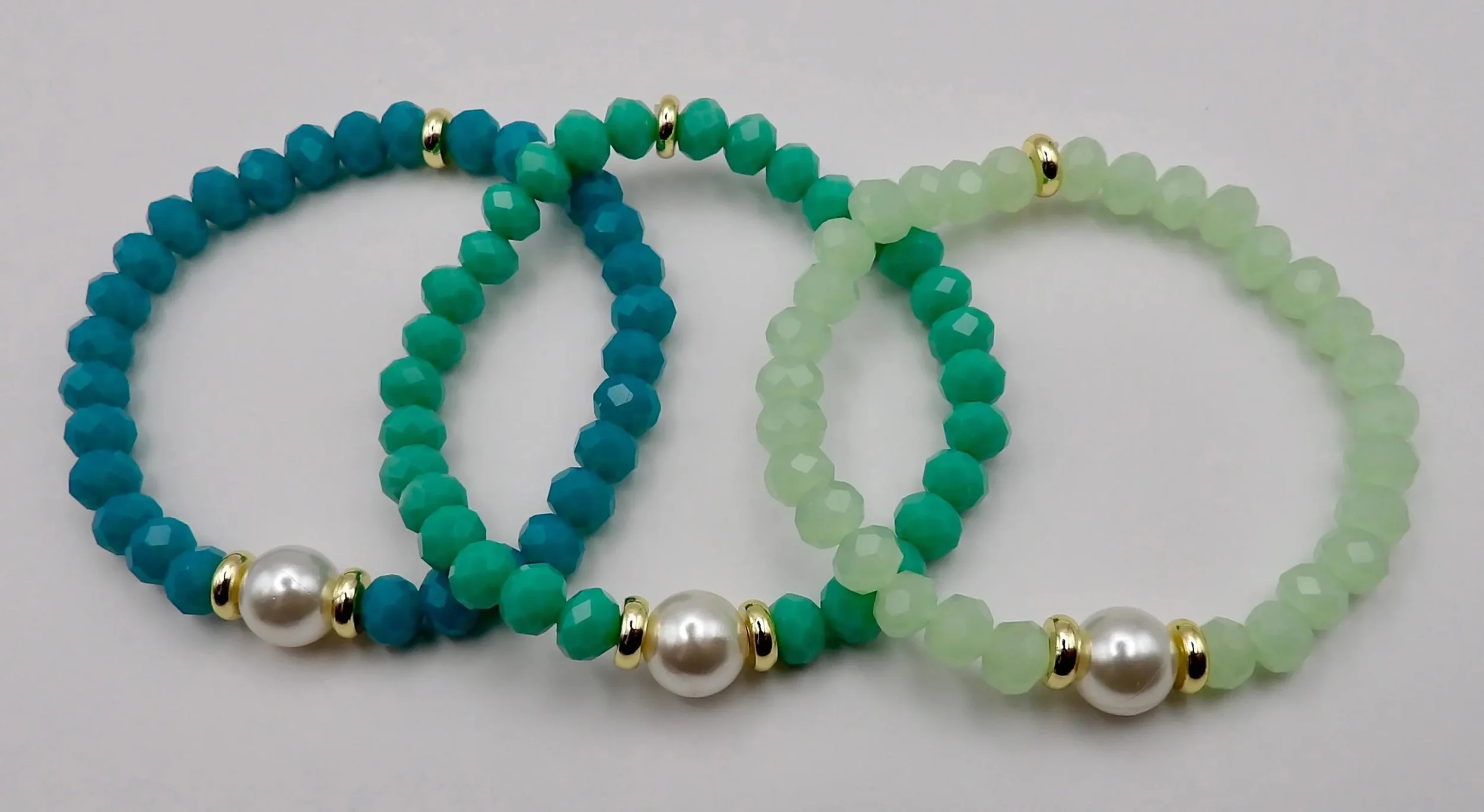 handcrafted ocean-inspired jewelry featuring a tarnish-resistant gold finish, genuine mother of pearl, and light-catching glass beads.