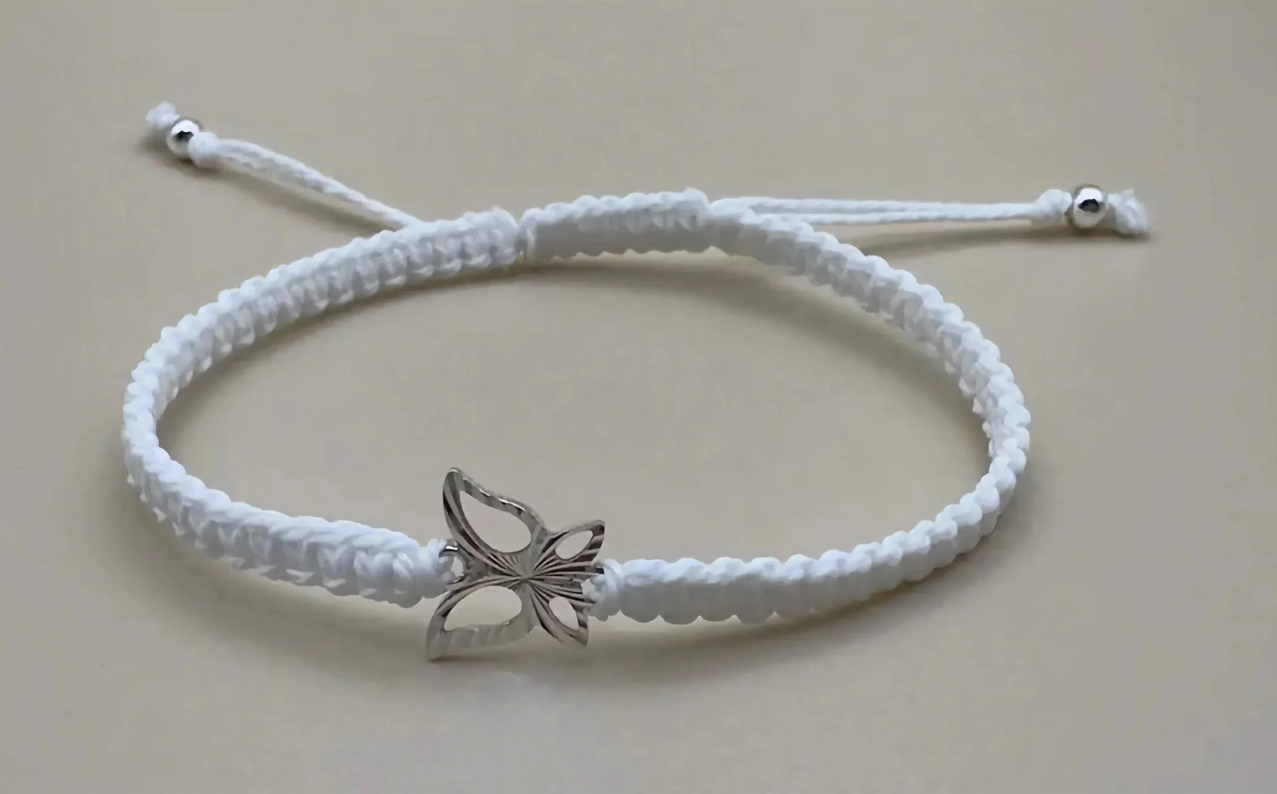 a versatile and bridal-ready white macramé bracelet featuring a high-quality sterling silver butterfly charm.