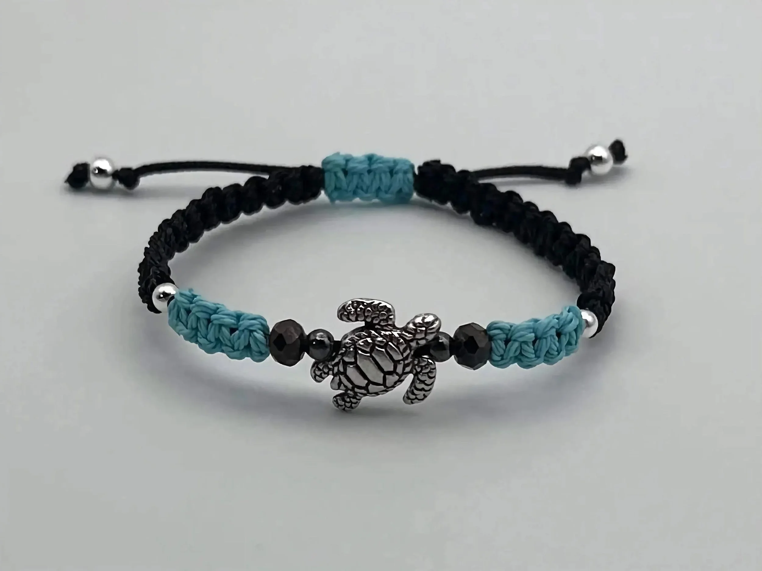 a versatile unisex ocean-inspired bracelet that is fully adjustable, waterproof, and fade-resistant for daily wear.
