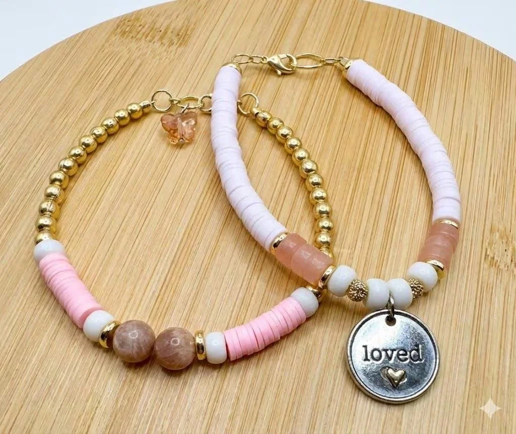 handcrafted rose quartz and sunstone beads showing a mix of translucent pink and metallic-flecked orange tones.