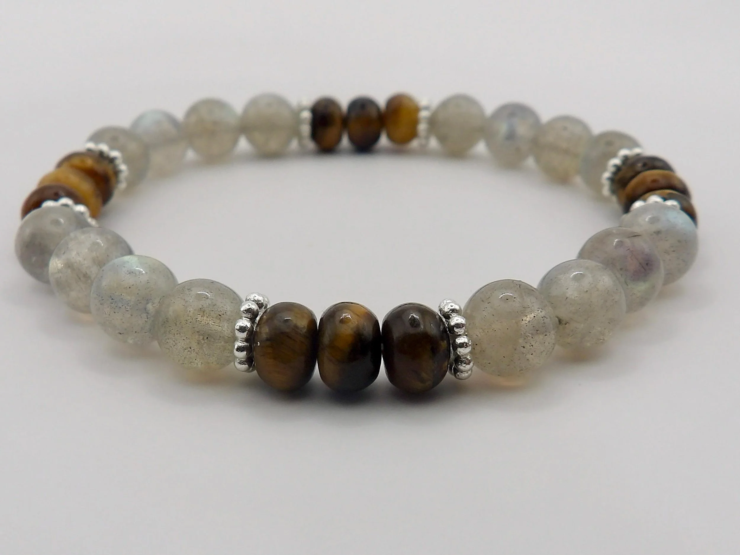 a resilient and tarnish-proof stretch bracelet featuring a balancing mix of reflective minerals and a premium hypoallergenic silver daisy hallmark.
