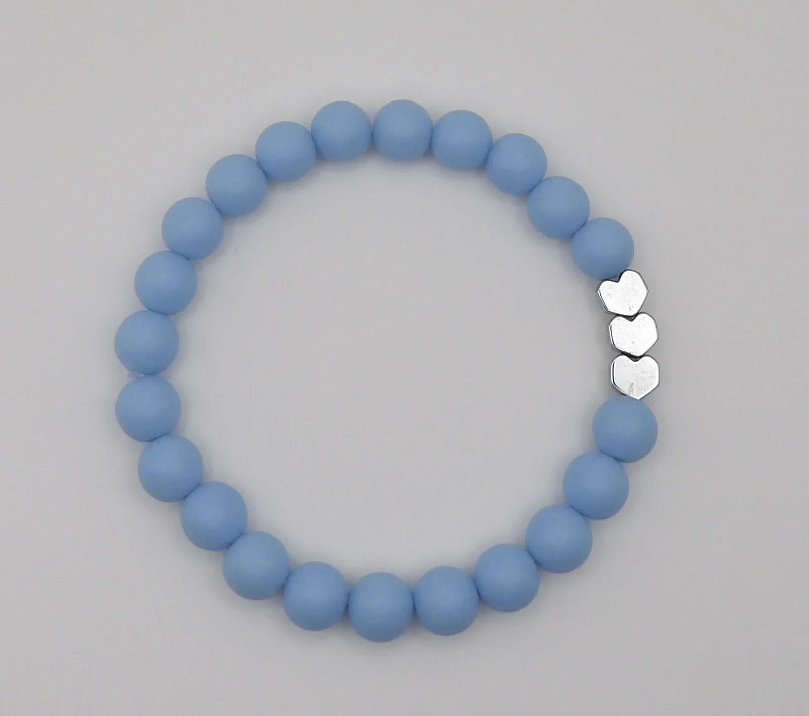 sweet dreams matte heart bracelet in soft baby blue color with a shiny silver heart accent bead.