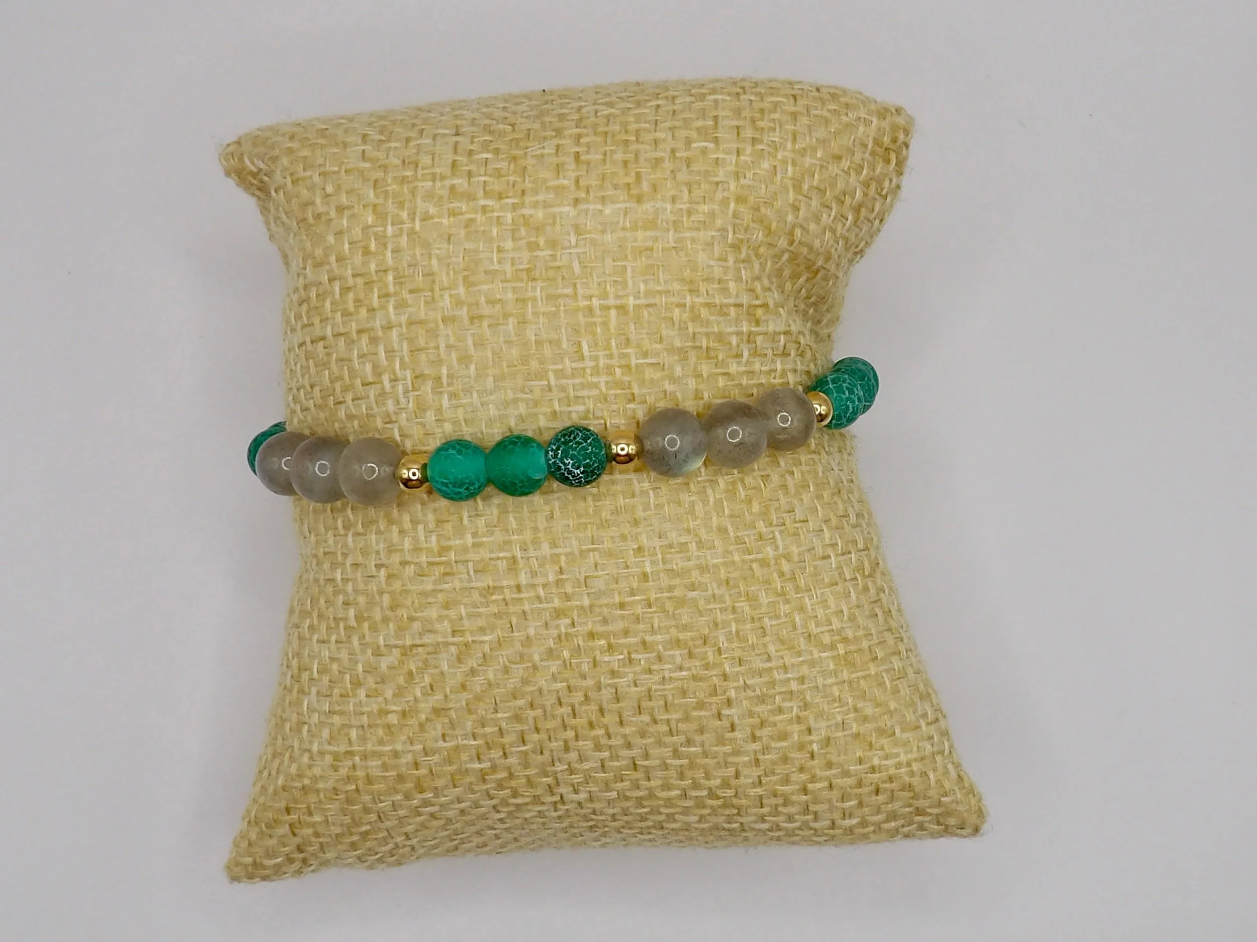 close-up detail showing the matte texture and unique cracks of the green fire cracked agate beads next to a 4mm 18k solid gold bead.