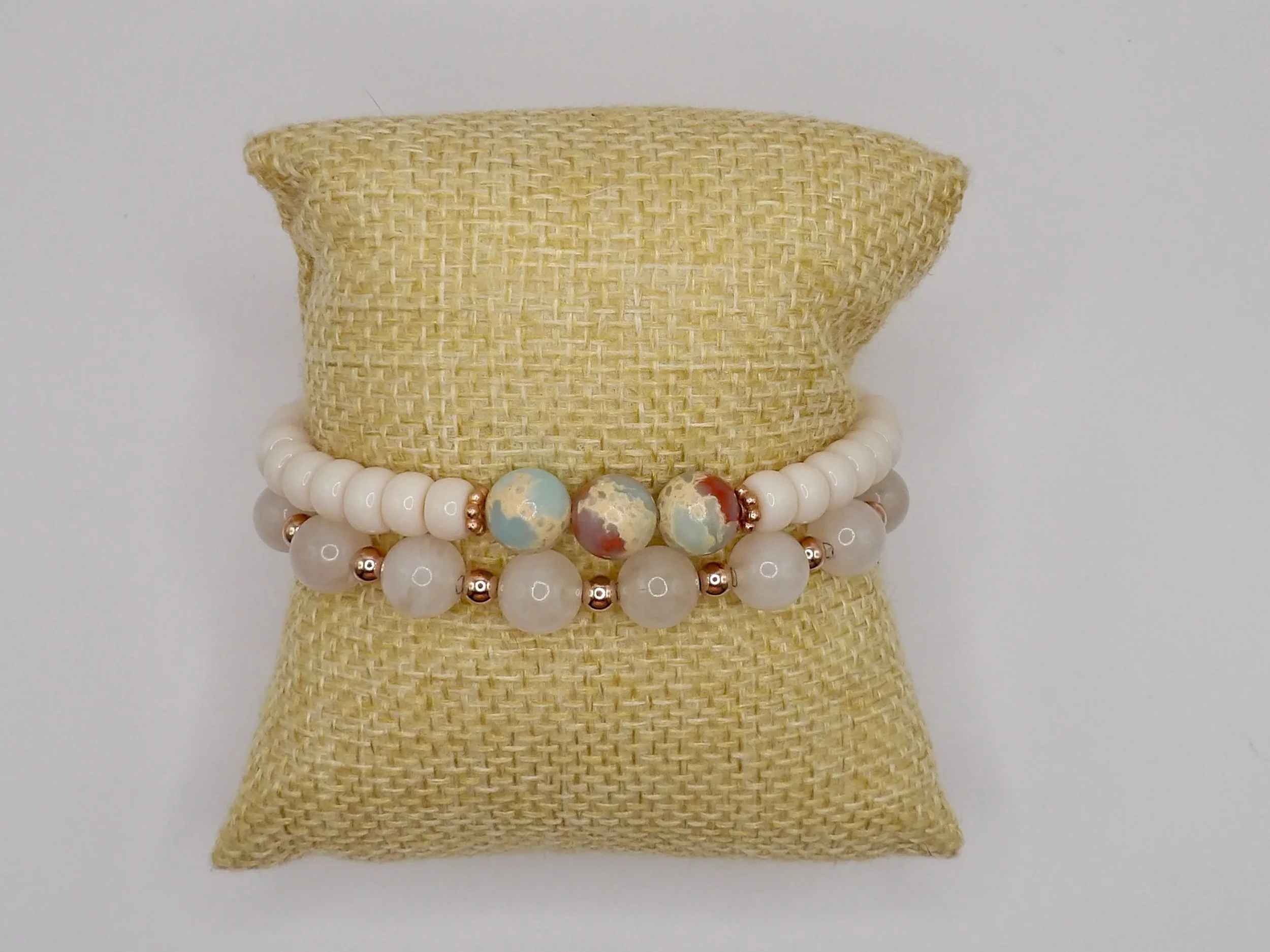 close-up detail showing the three 8mm blue african opal beads nestled between two 14k solid rose gold daisy spacer beads.