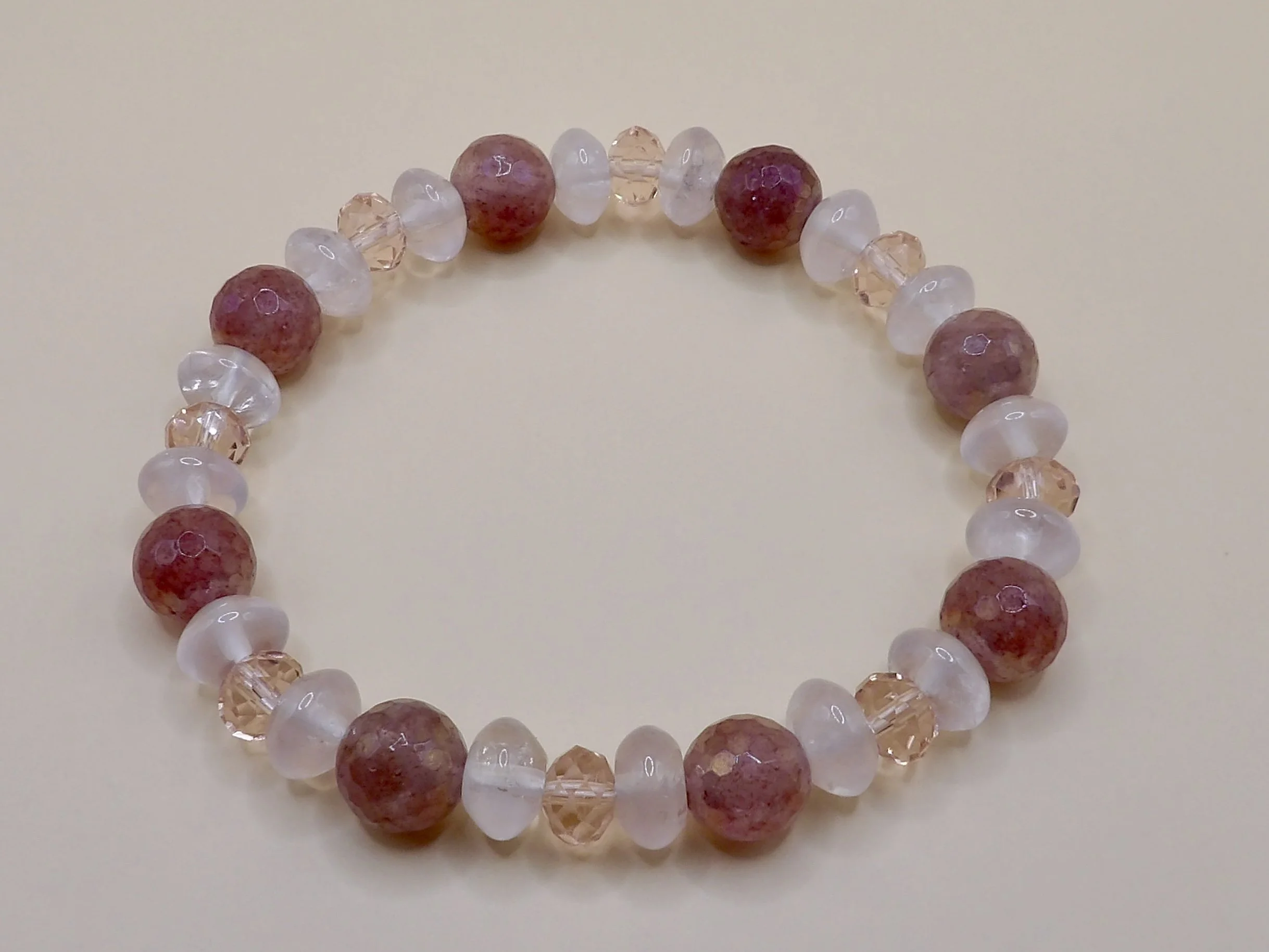 person wearing the 2-piece pink gemstone bracelet stack, showing the 14k rose gold and mixed quartz bracelets together.
