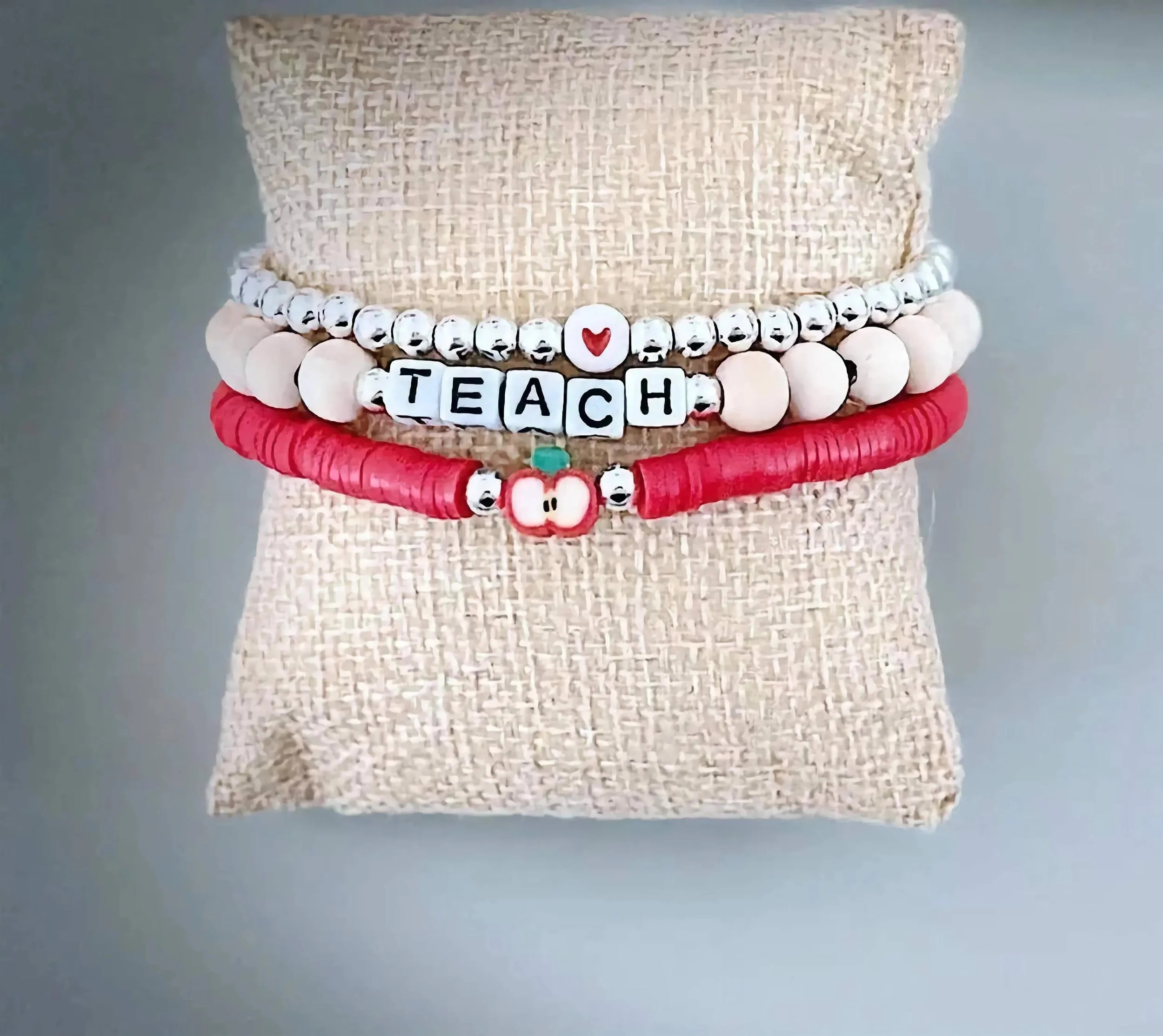 handcrafted classic educator bracelet stack in polished sterling silver featuring three 5mm bead bracelets with a red apple charm.