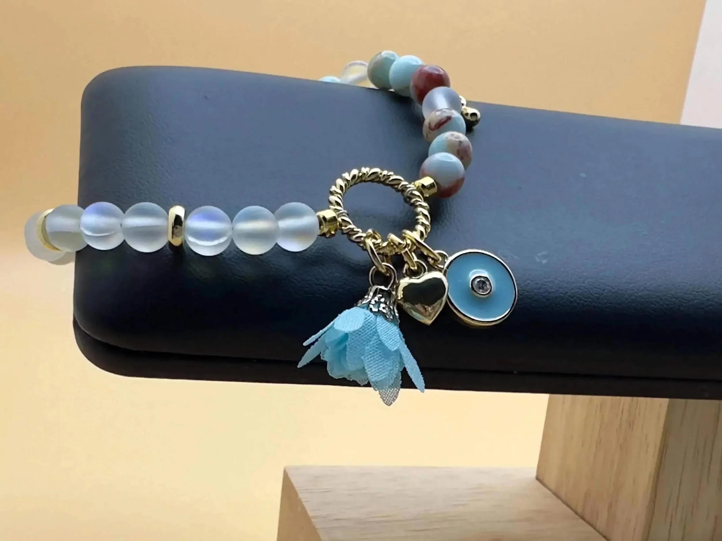 detailed view of the blue opal and spectrolite charms, showcasing the high-quality gold-filled finish and delicate craftsmanship.