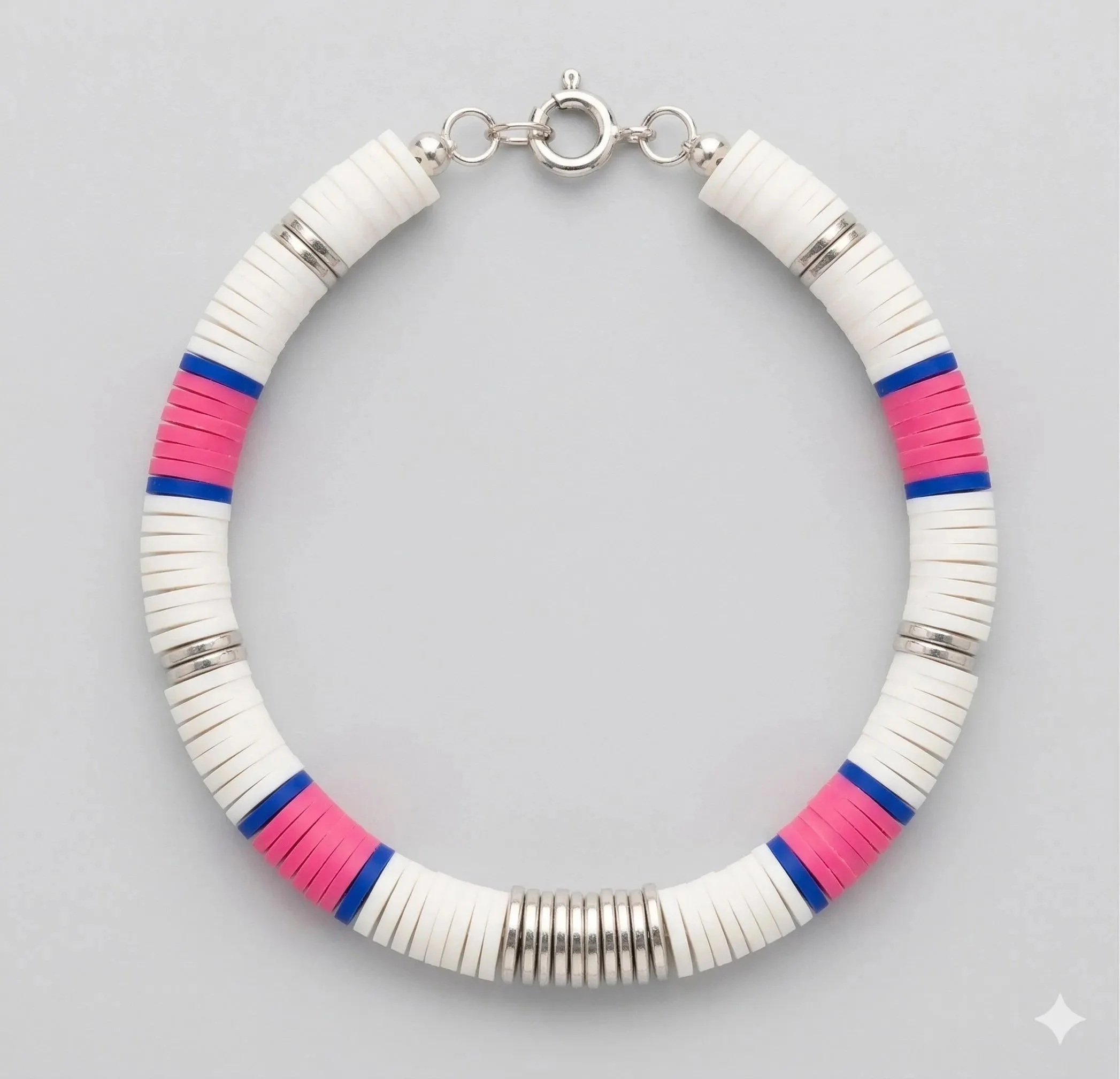 the preppy trendsetter bracelet featuring a bold color-block design of hot pink and navy clay heishi beads with silver hematite accents.