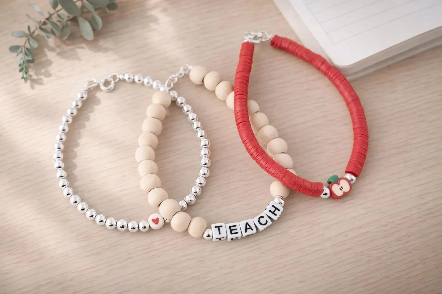 minimalist silver teacher stack with a small red apple focal bead designed for a sophisticated school-day look.