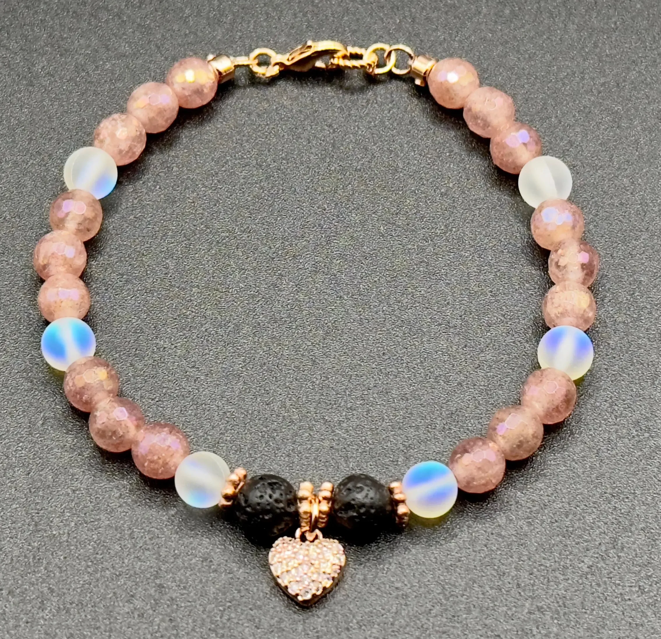 Handmade gemstone bracelet with mystic strawberry quartz, spectrolite, and lava rock, finished with a 14k rose gold heart charm.