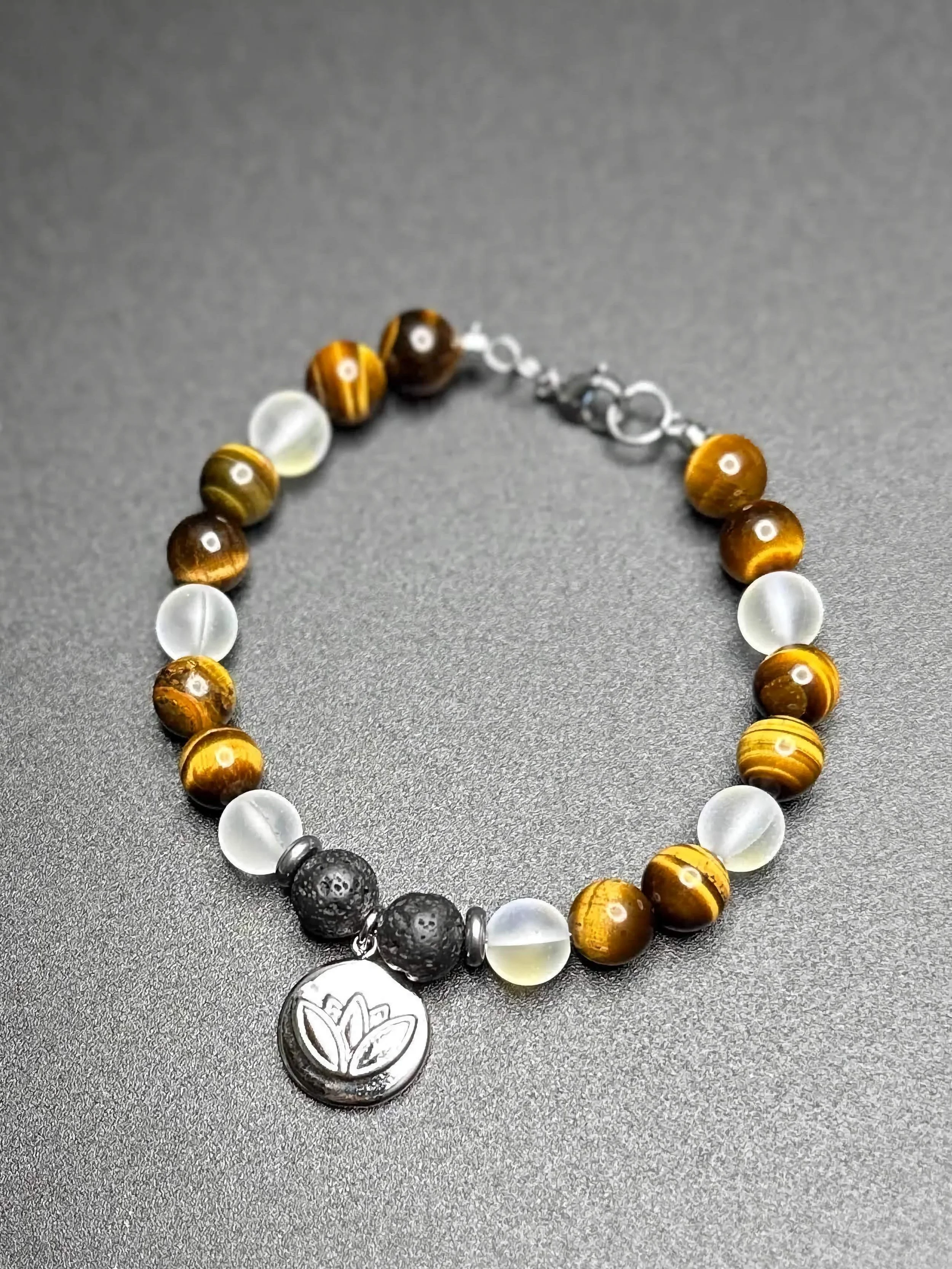 A close-up of a handmade chakra bracelet with 7 different colored gemstones.