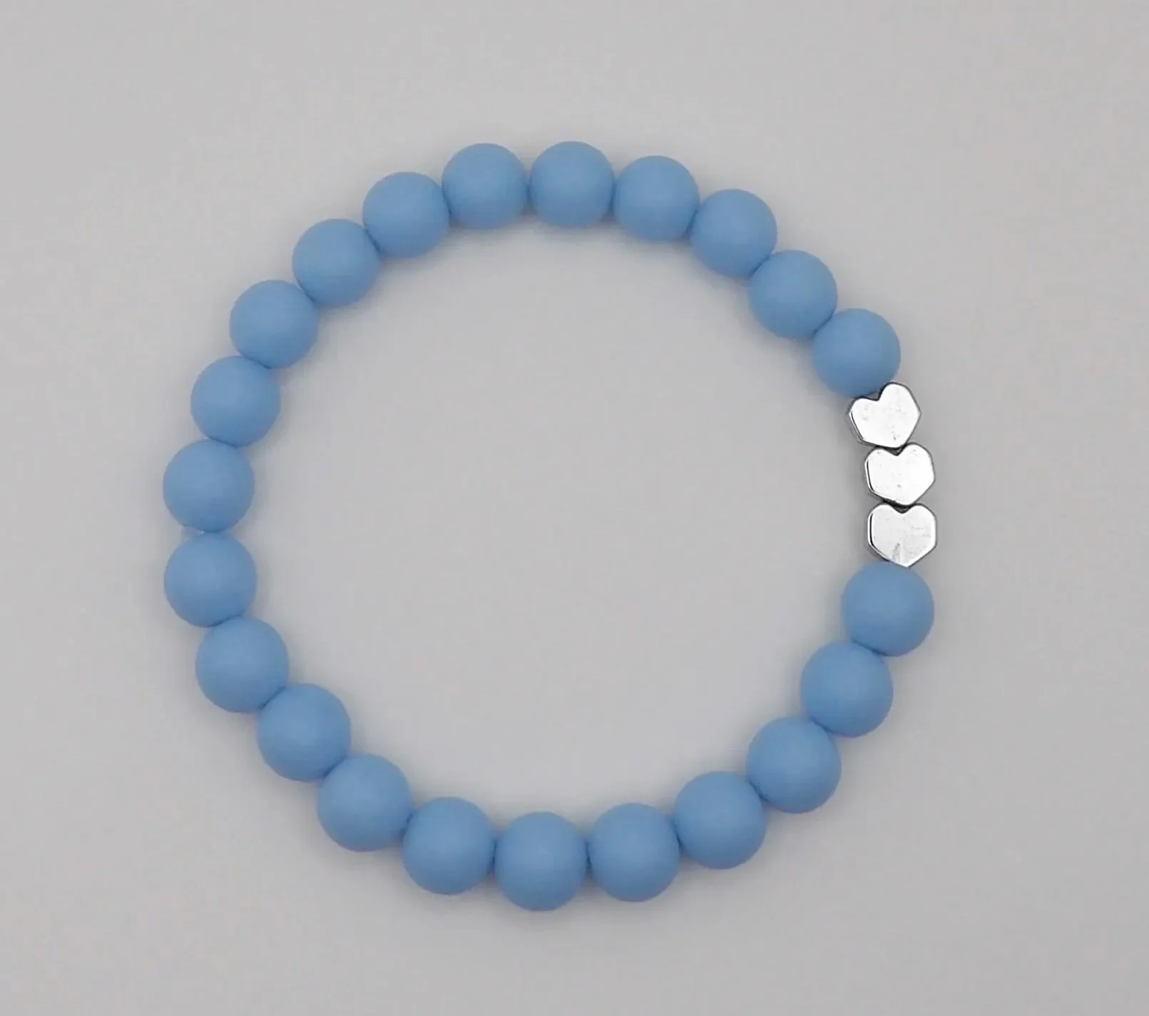 a vibrant matte heart stacking bracelet designed to bring a touch of playful energy to a minimalist wardrobe.