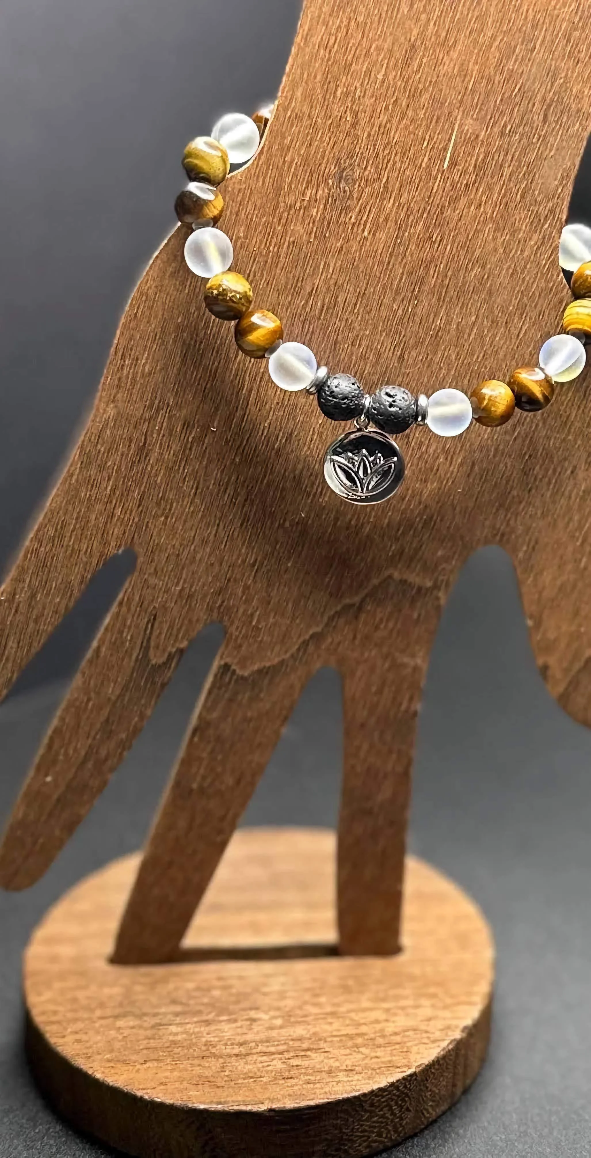 A close-up of a handmade chakra bracelet with 7 different colored gemstones.
