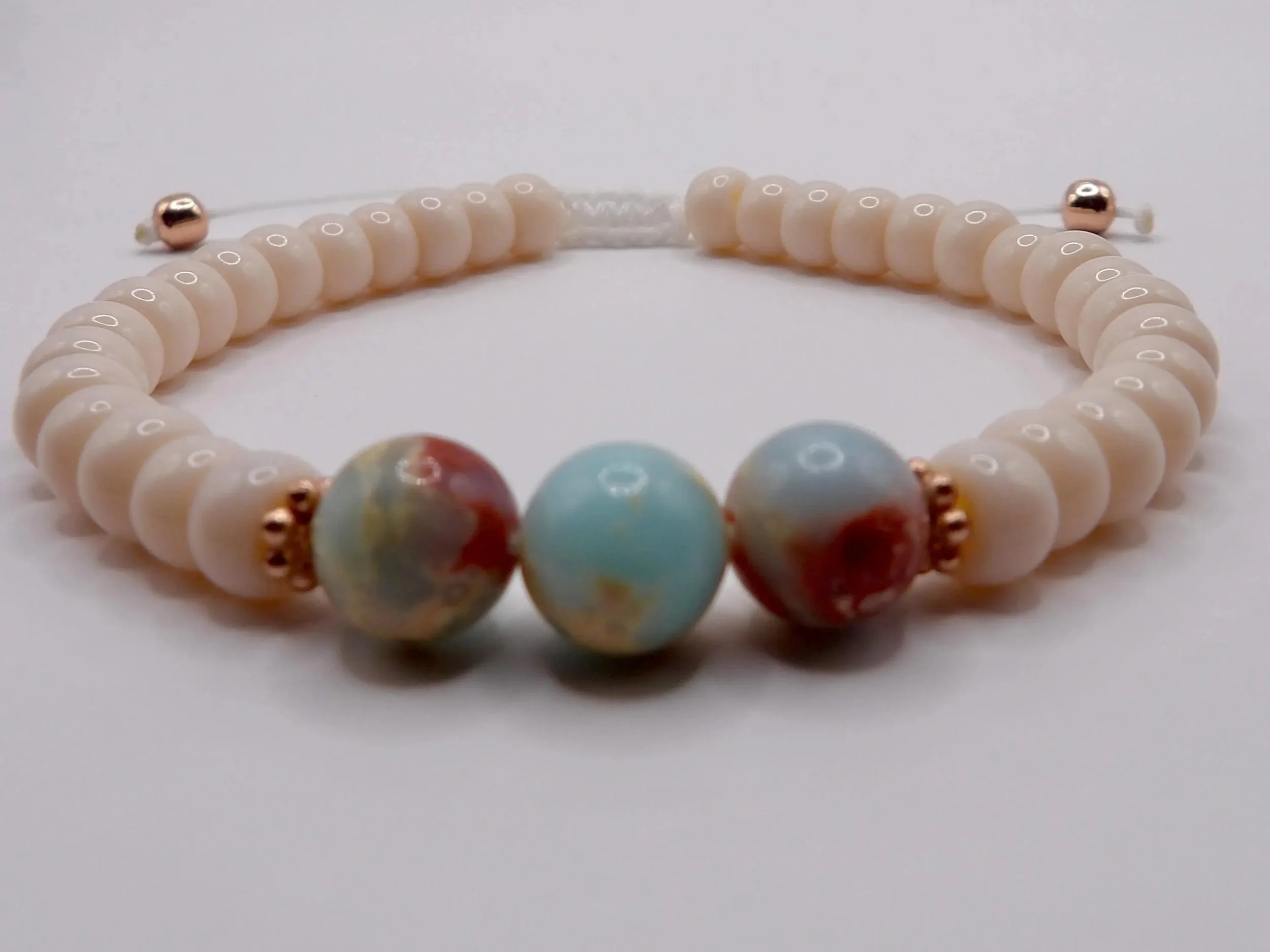 close-up of the coastal opal bracelet highlighting the delicate rose gold hardware and the organic texture of the gemstones.