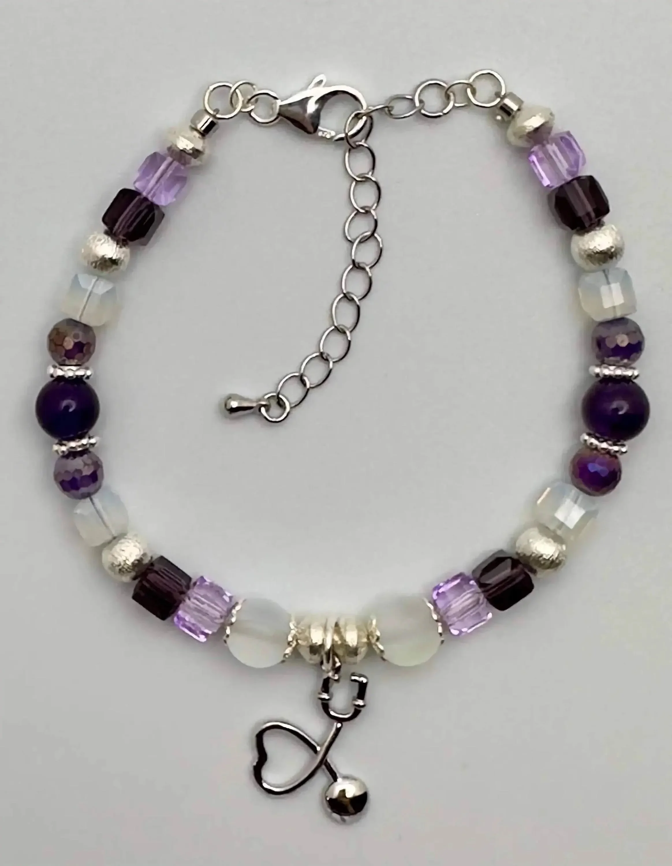 the healer’s heartbeat set styled to showcase the layered aesthetic of different textures and metallic silver finishes.