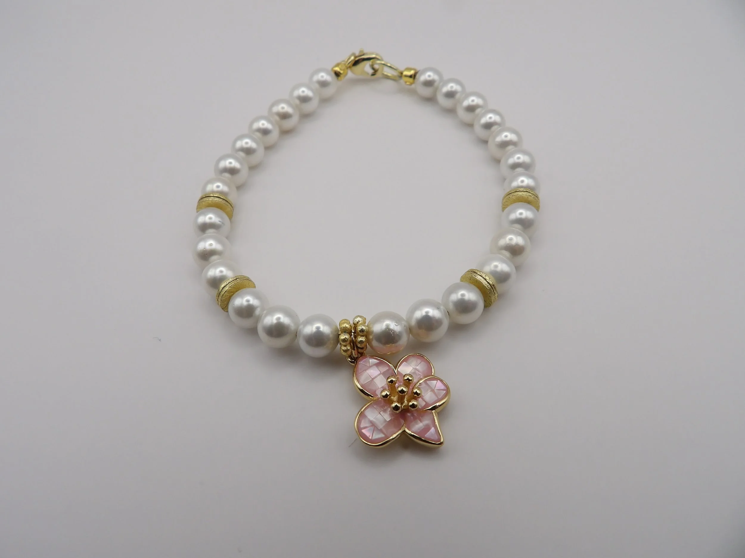 gold and pearl pink hanging charm flower bracelet.