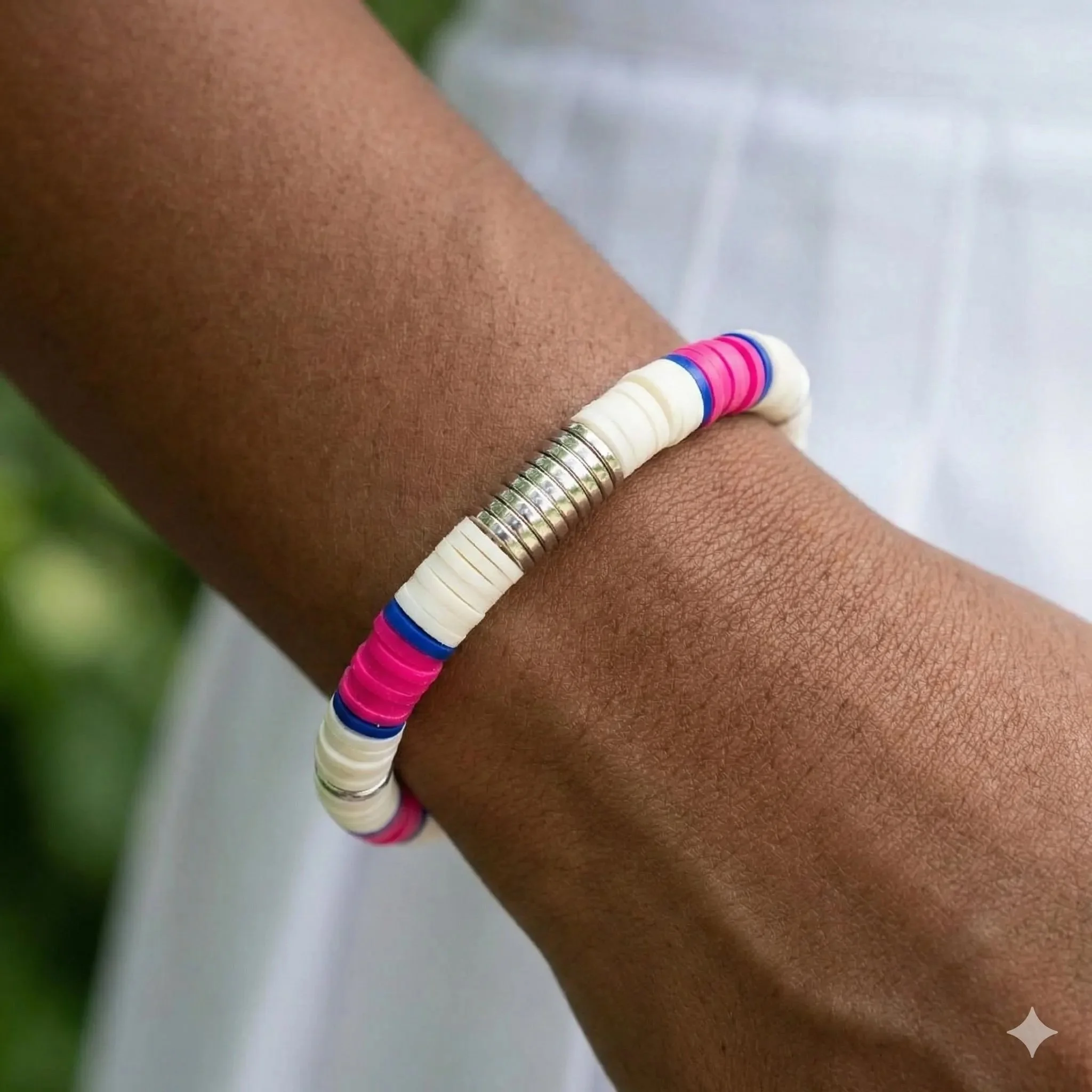 vibrant hot pink and navy blue heishi bead bracelet with polished silver hematite spacers for a preppy, high-contrast look.