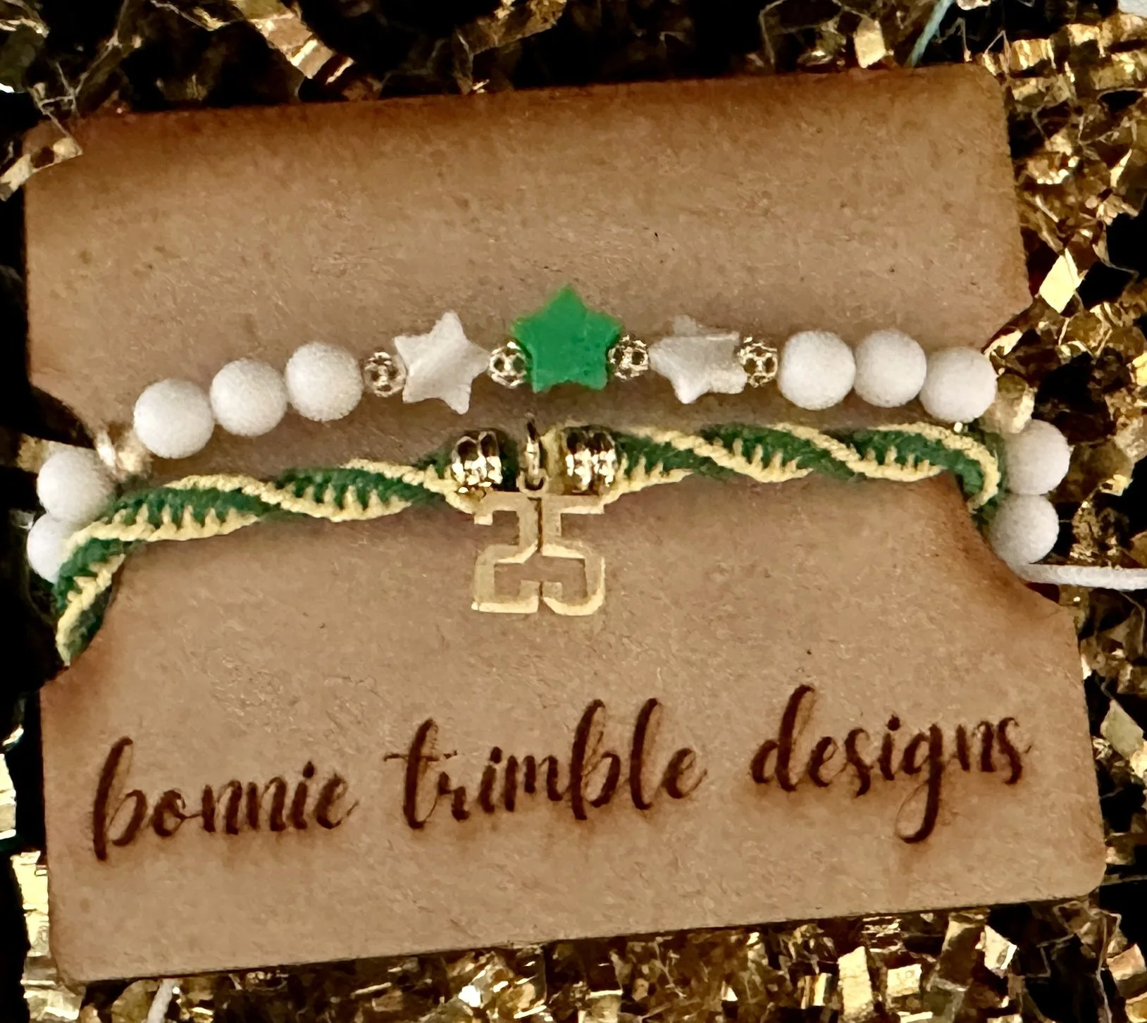 close-up detail of the shiny 18k gold number charm and flat heishi disc spacer beads on the custom woven macrame cord bracelet.