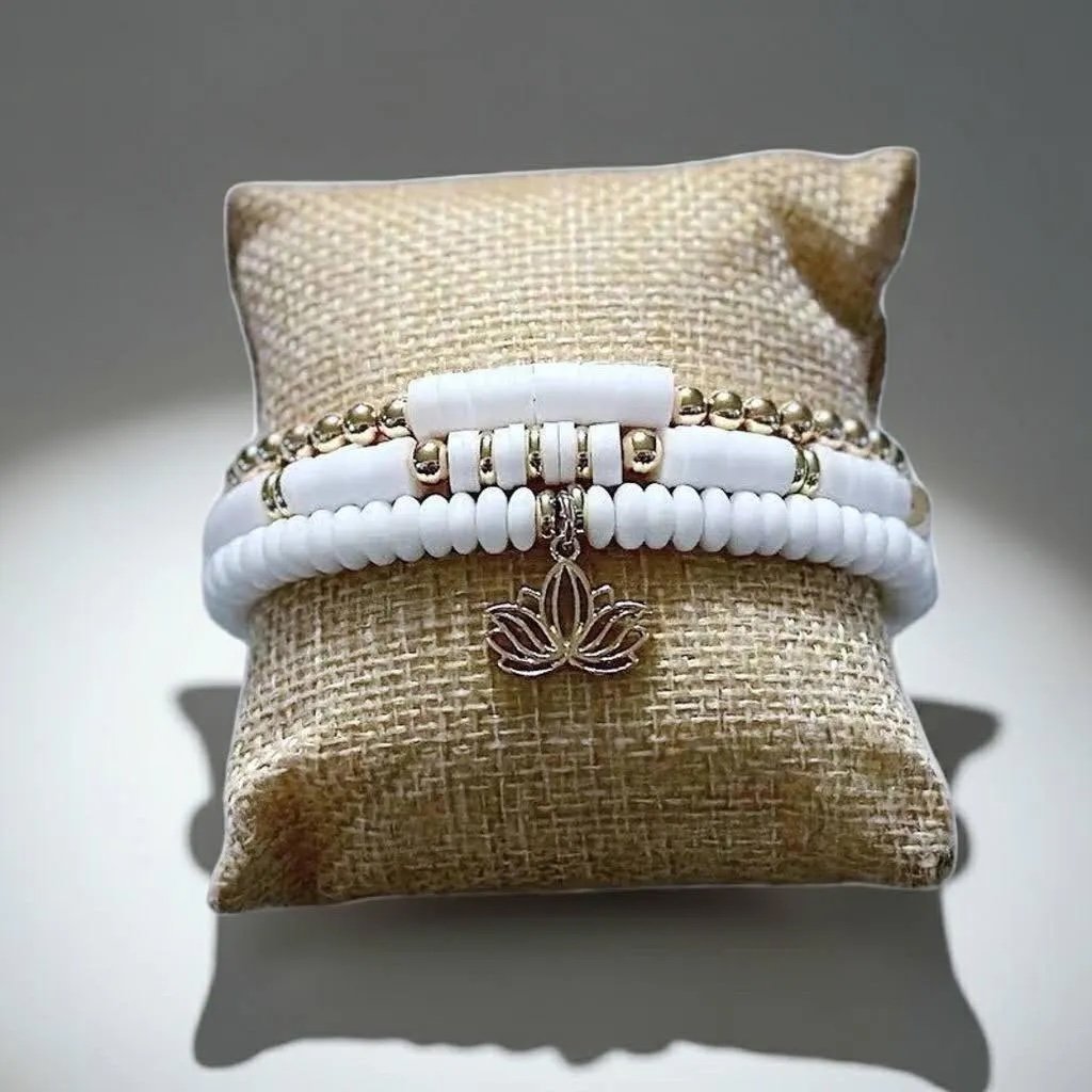 Minimalist white and gold yogi bracelet 3-piece set featuring soft-touch matte glass textures and a polished lotus focal.