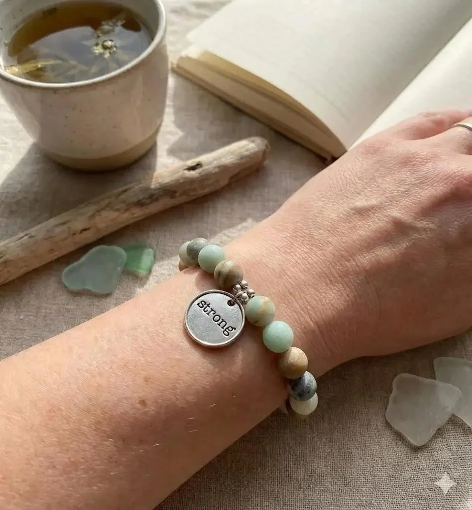 matte amazonite gemstone bracelet in soft sea-foam green with a customizable silver charm and an adjustable sliding closure.