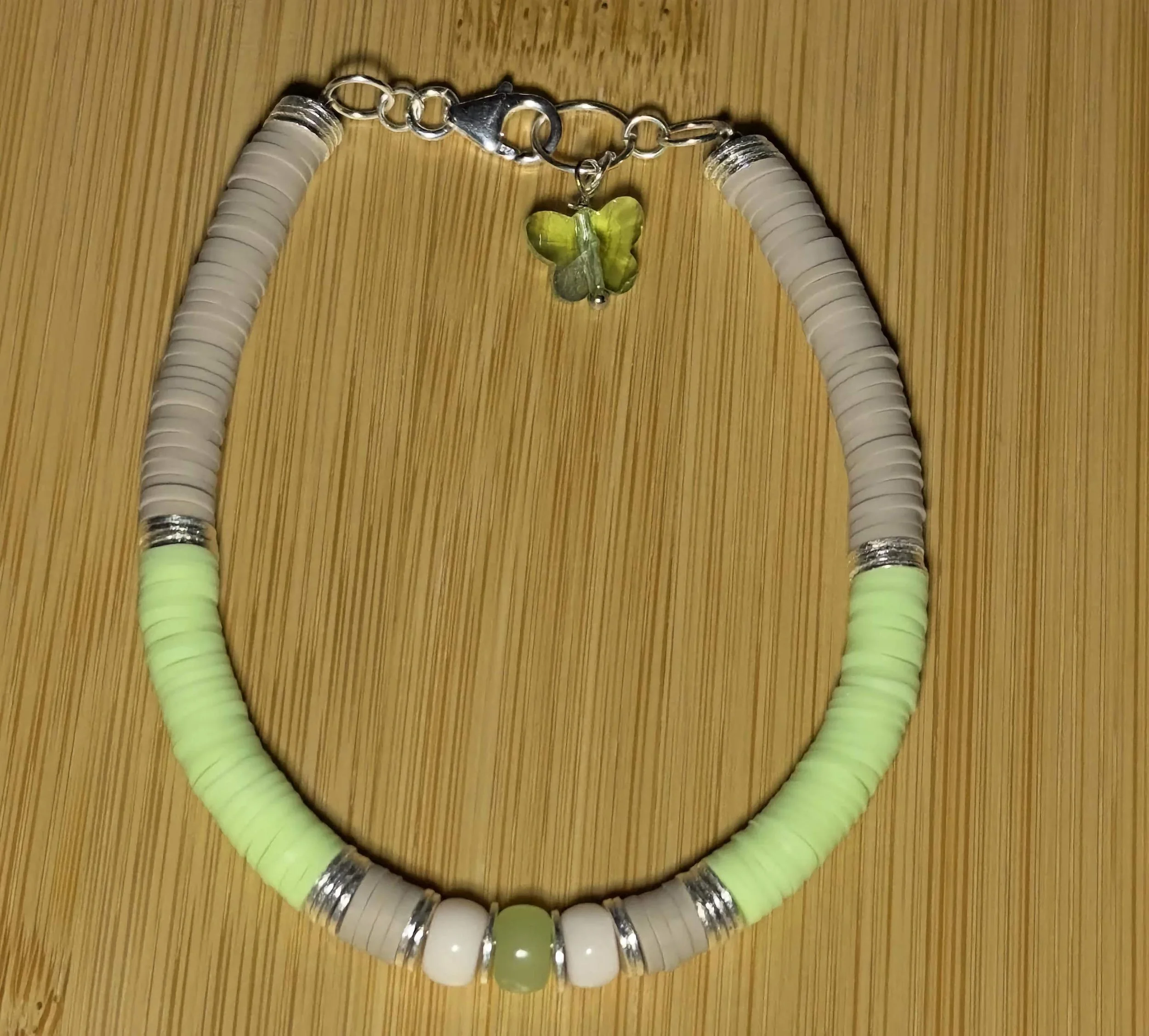 high-resolution product shot of the butterfly custom bracelet on a neutral linen background to show color vibrancy.