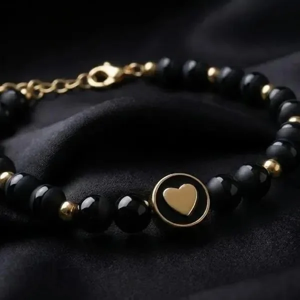 adjustable black onyx beaded bracelet with a mix of high-shine and matte textures accented by 18k gold plated hardware.