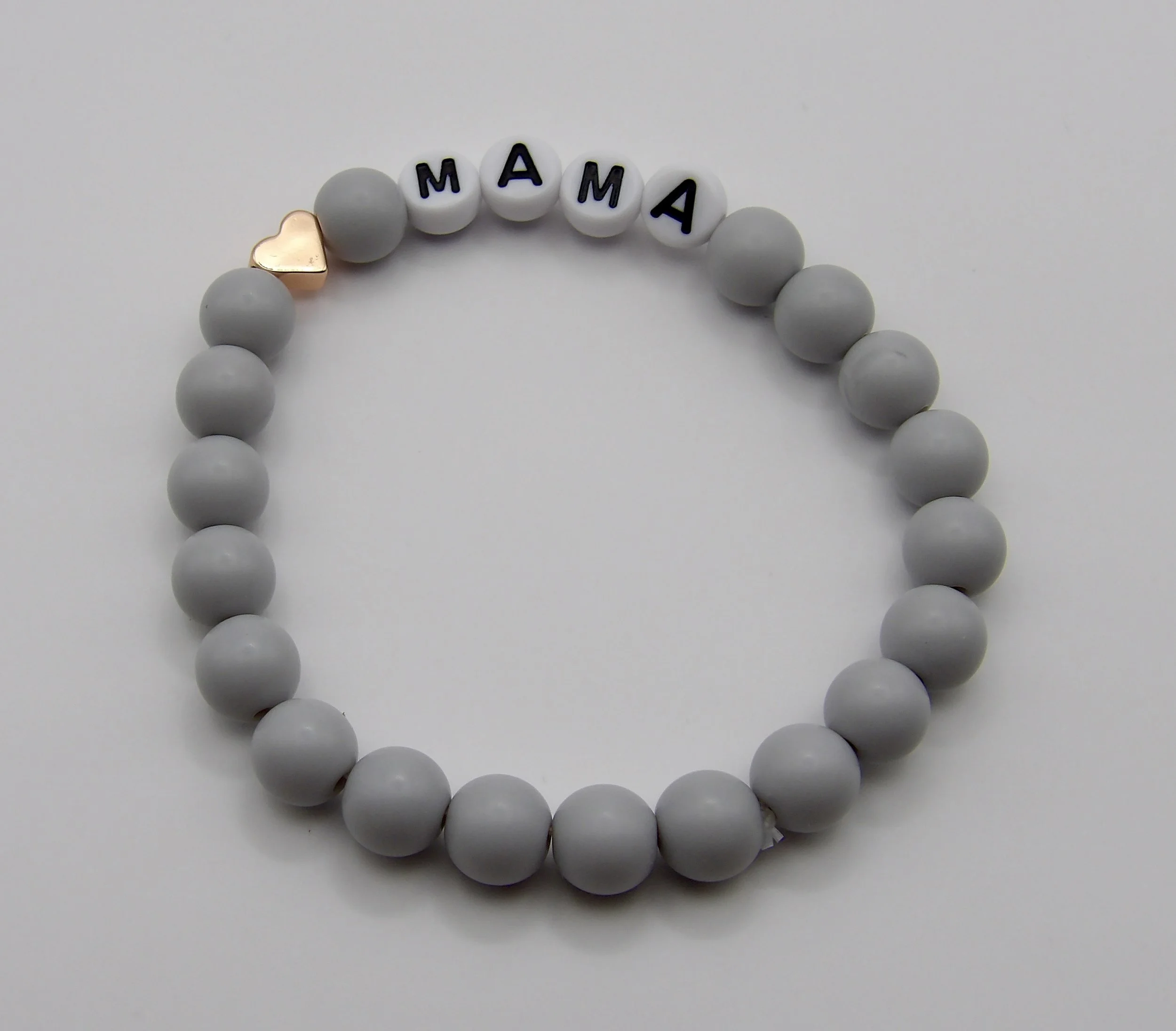 gray matte “mama” bracelet with rose gold heart shown in elegant gift packaging, ready for mother’s day or a new mom gift.