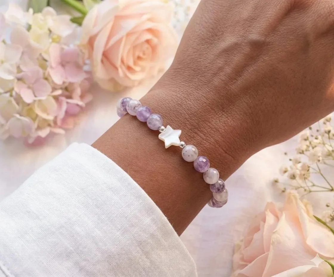 a dainty and ethereal gemstone stretch bracelet showing the contrast between the pastel purple jade tones and the high-luster glow of the central pearl star focal.
