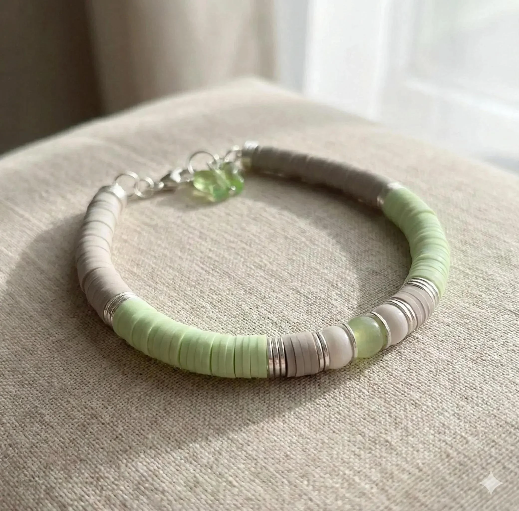 close-up of the butterfly custom bracelet highlighting the shimmering silver wings and the high-quality texture of the heishi beads.