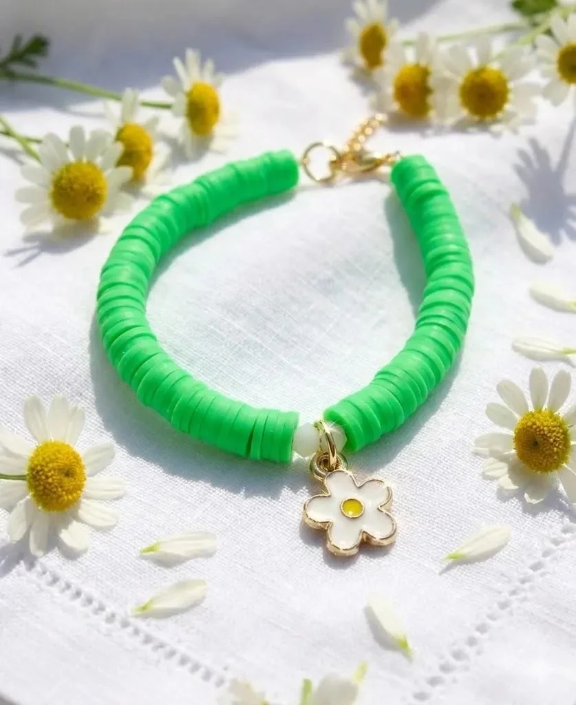 close-up of the sunny daisy bracelet highlighting the delicate crystal accents and the high-shine gold plating of the daisy.