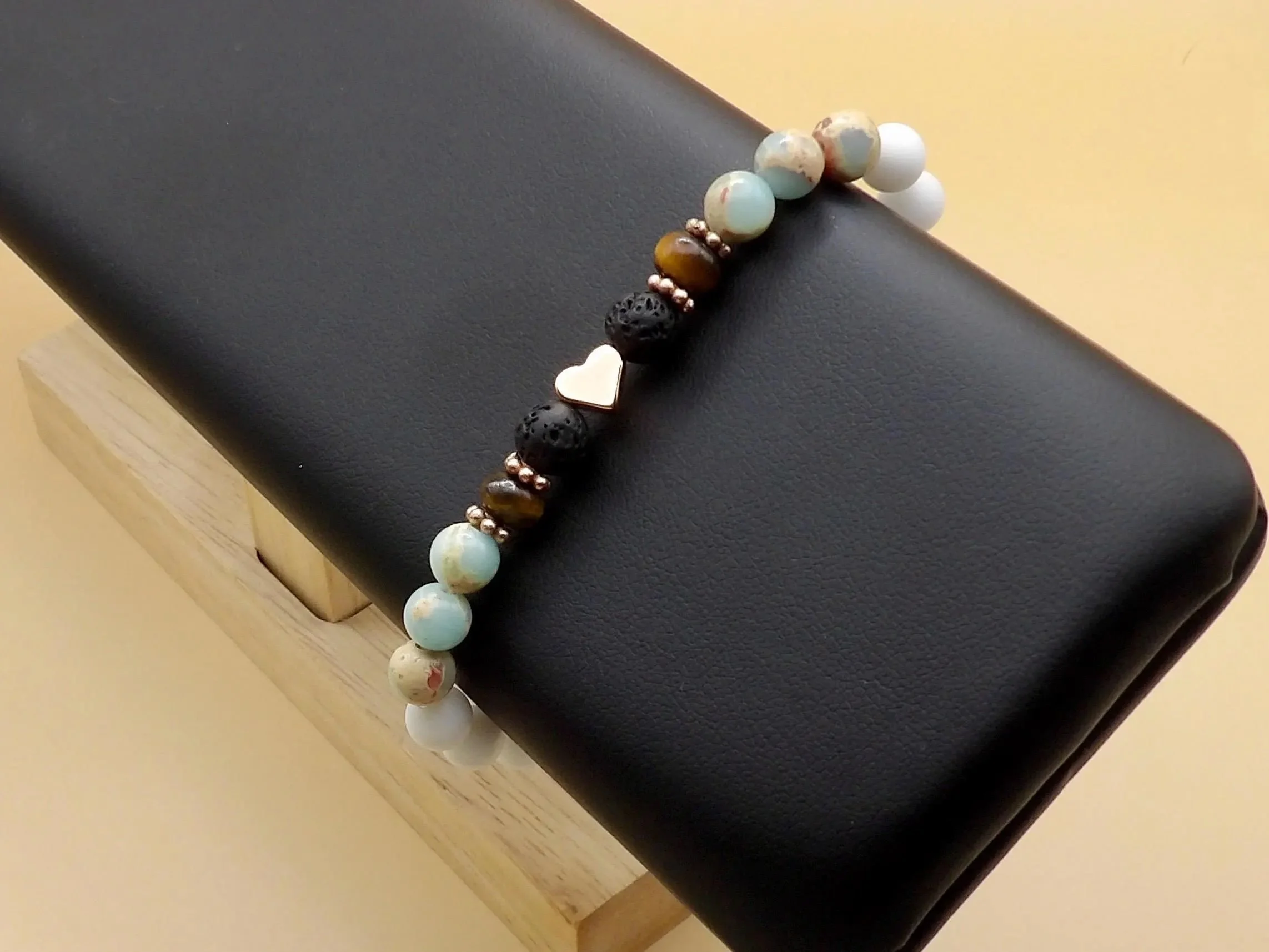 a meaningful self-care gift featuring "grounding" lava stones and "romantic" mixed gems, finished with premium rose gold hardware.