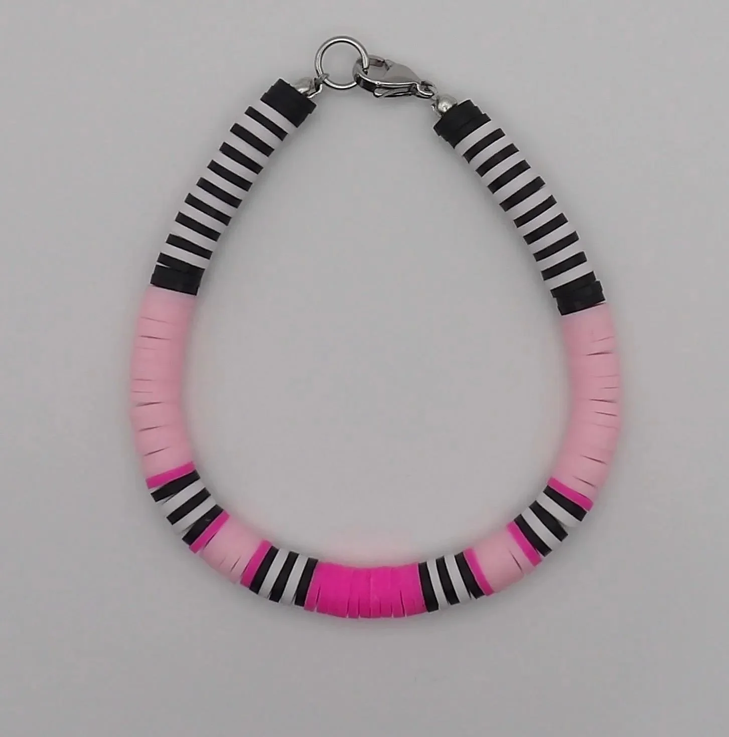 close-up of the energetic perfectionist bracelet highlighting the matte texture of the clay heishi beads and the precise, repeating pattern.