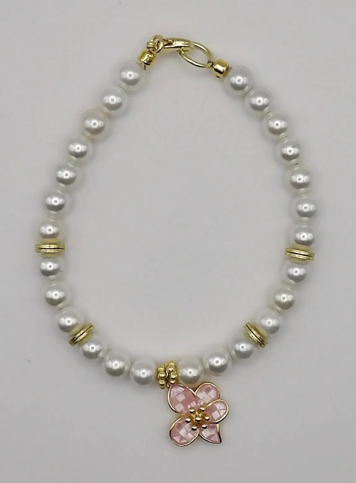 the classic bloom bracelet on a light linen background, showcasing its dainty silhouette and sea-inspired elegance.