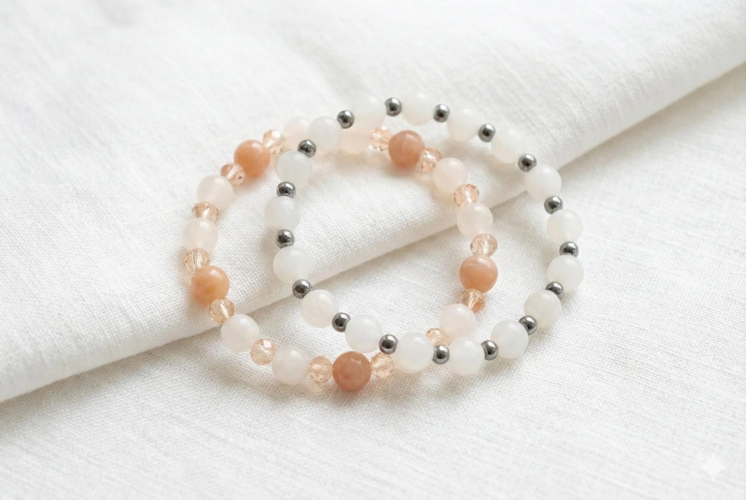 a serene gemstone jewelry set showing the gentle color transition between milky white jade and translucent rose quartz.