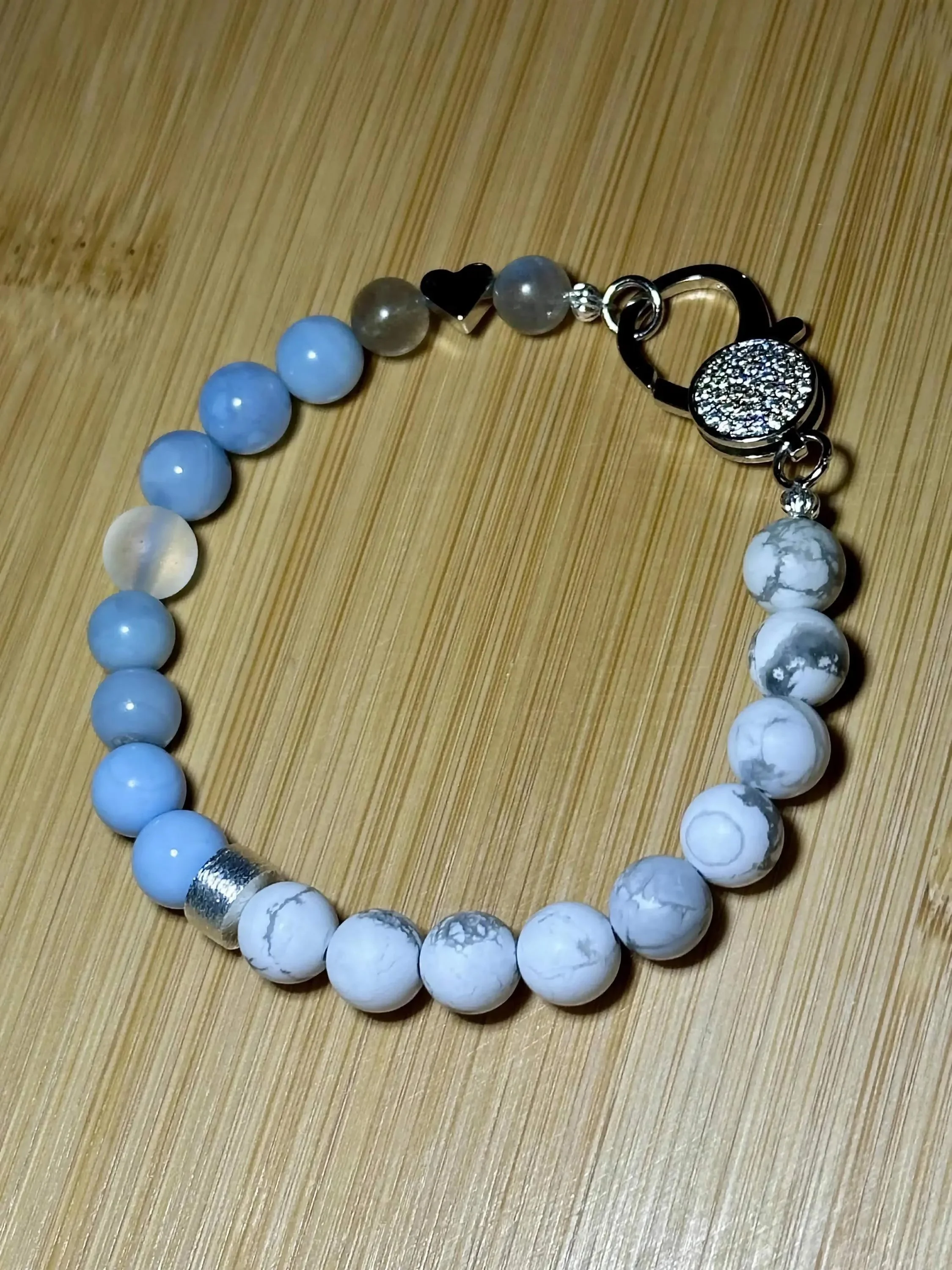 close-up of the pavé clasp statement bracelet showing the brilliant detail of the crystals and the serene tones of the blue lace agate.