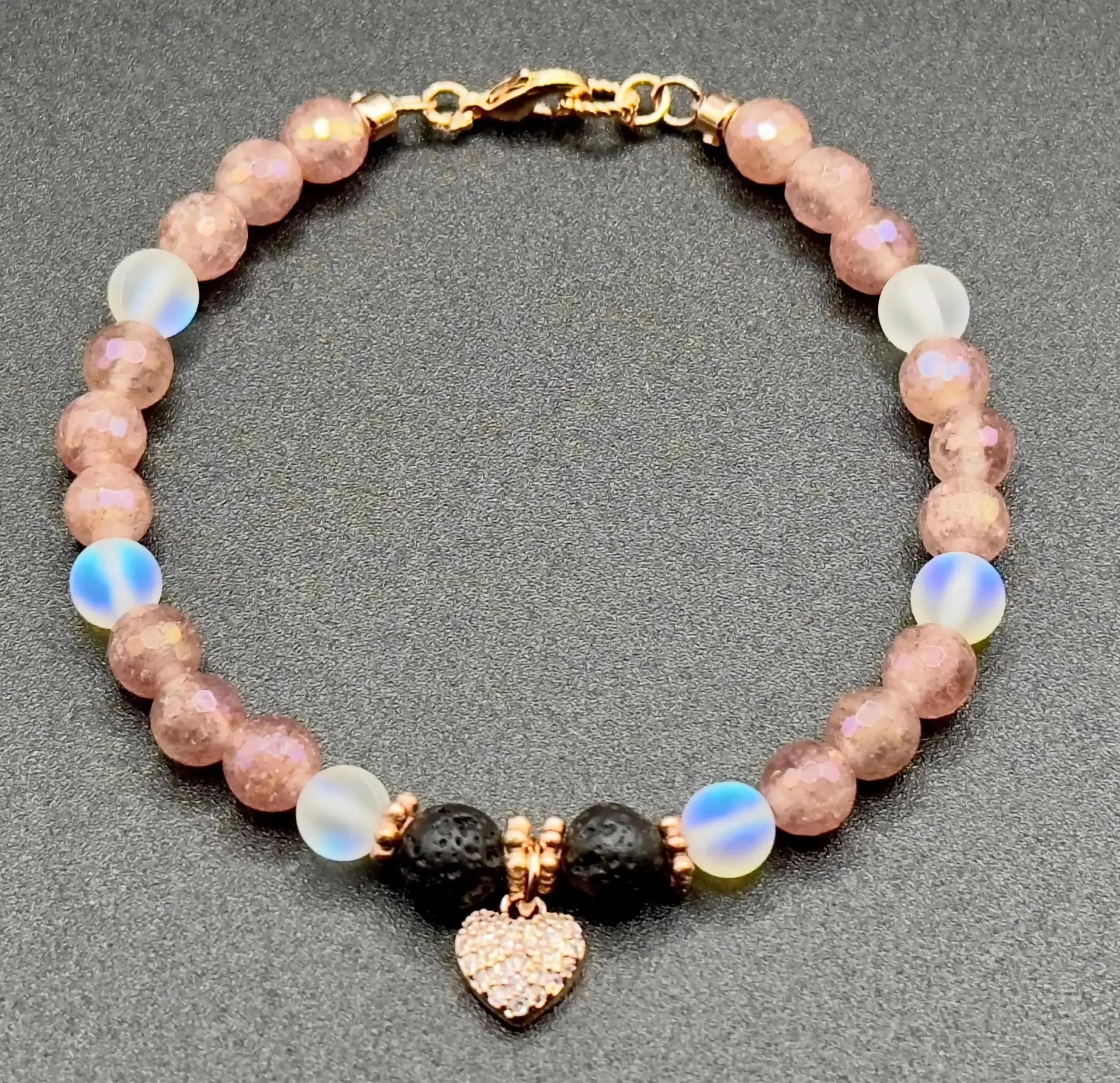 an adjustable romantic jewelry piece designed for aromatherapy, featuring natural pink crystals and a high-shine heart charm.