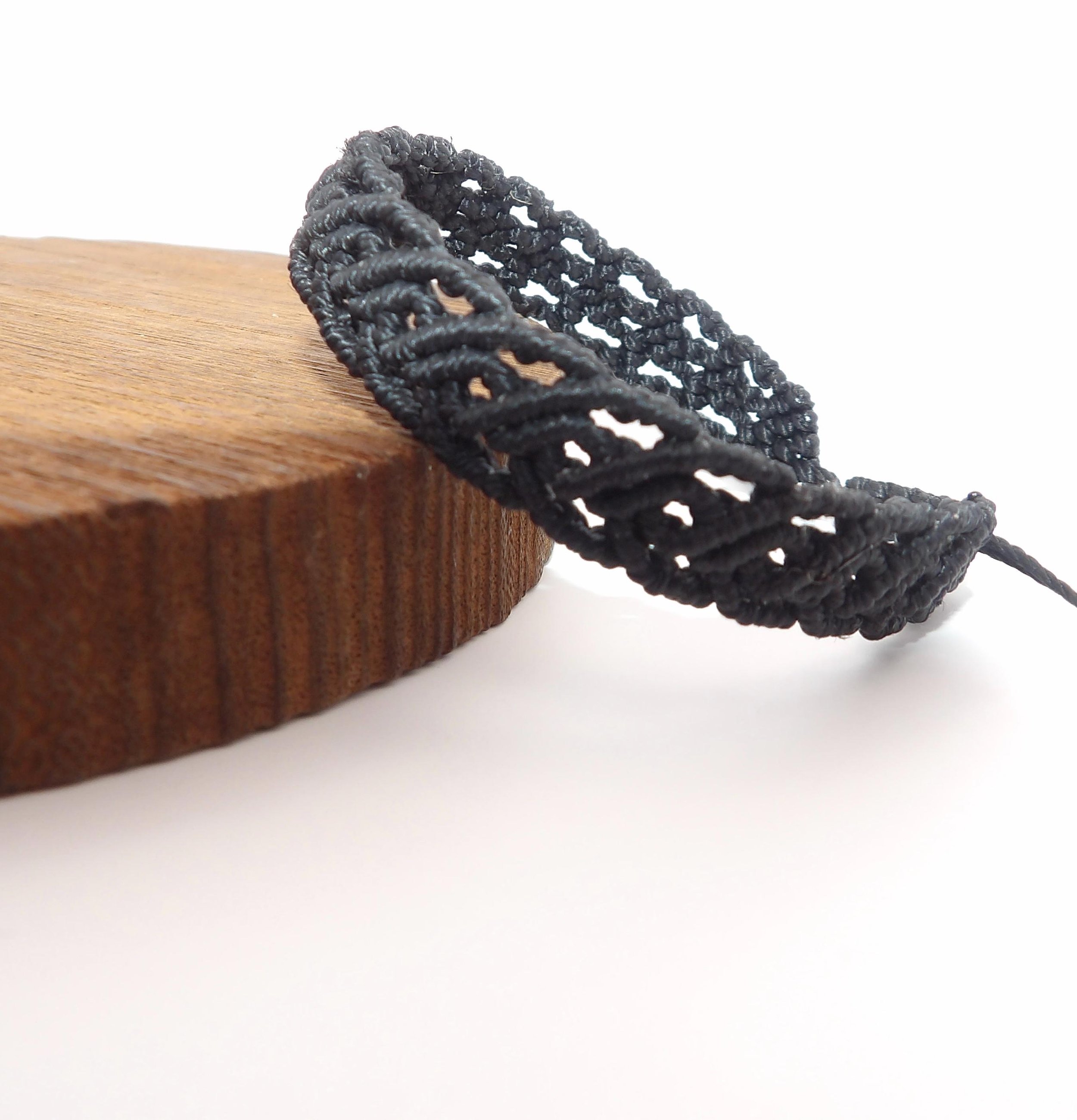 the scrollwork artisan bracelet styled in a deep "moody" palette to emphasize its architectural and textural depth.