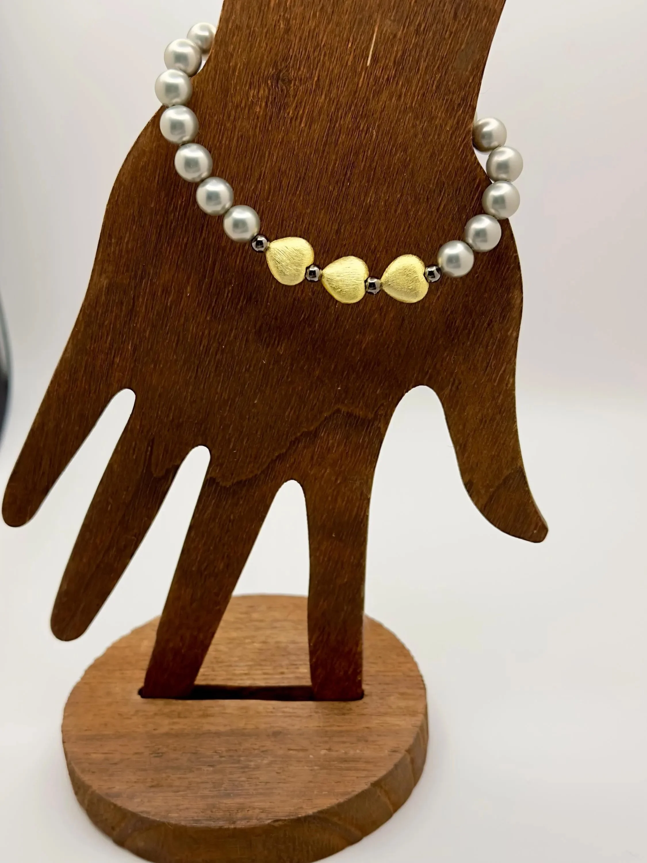 sophisticated mixed-metal jewelry piece with a vintage "vamp romantic" vibe, featuring gold and hematite.
