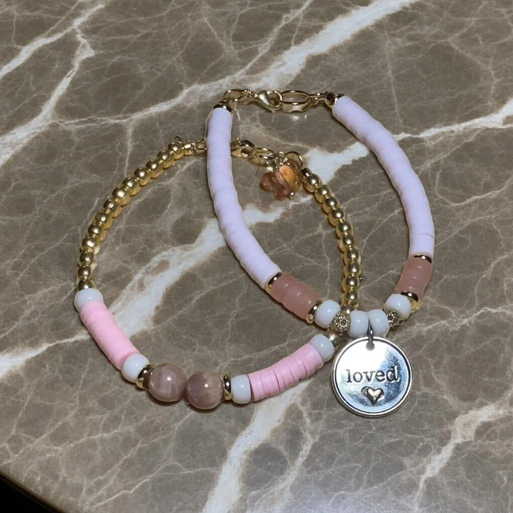 a curated three-piece jewelry stack featuring natural healing stones and gold-tone symbolic charms.