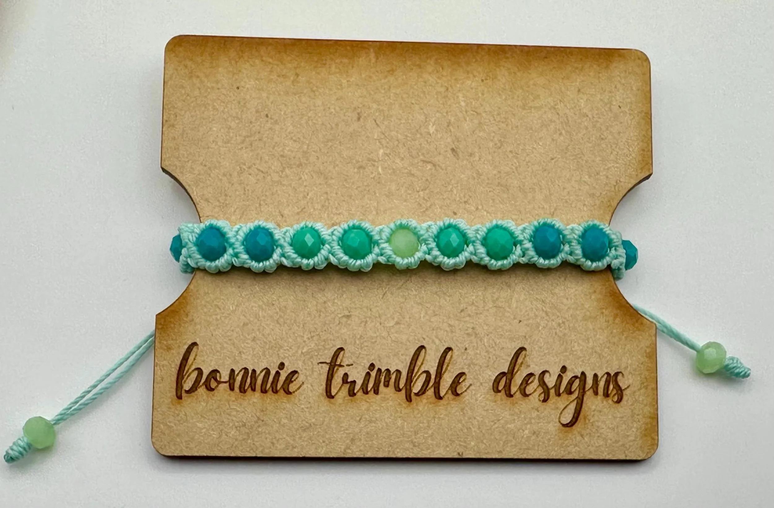 close-up of the sea glass gradient bracelet highlighting the frosted color palette and the precision of the artisan micro-weave.