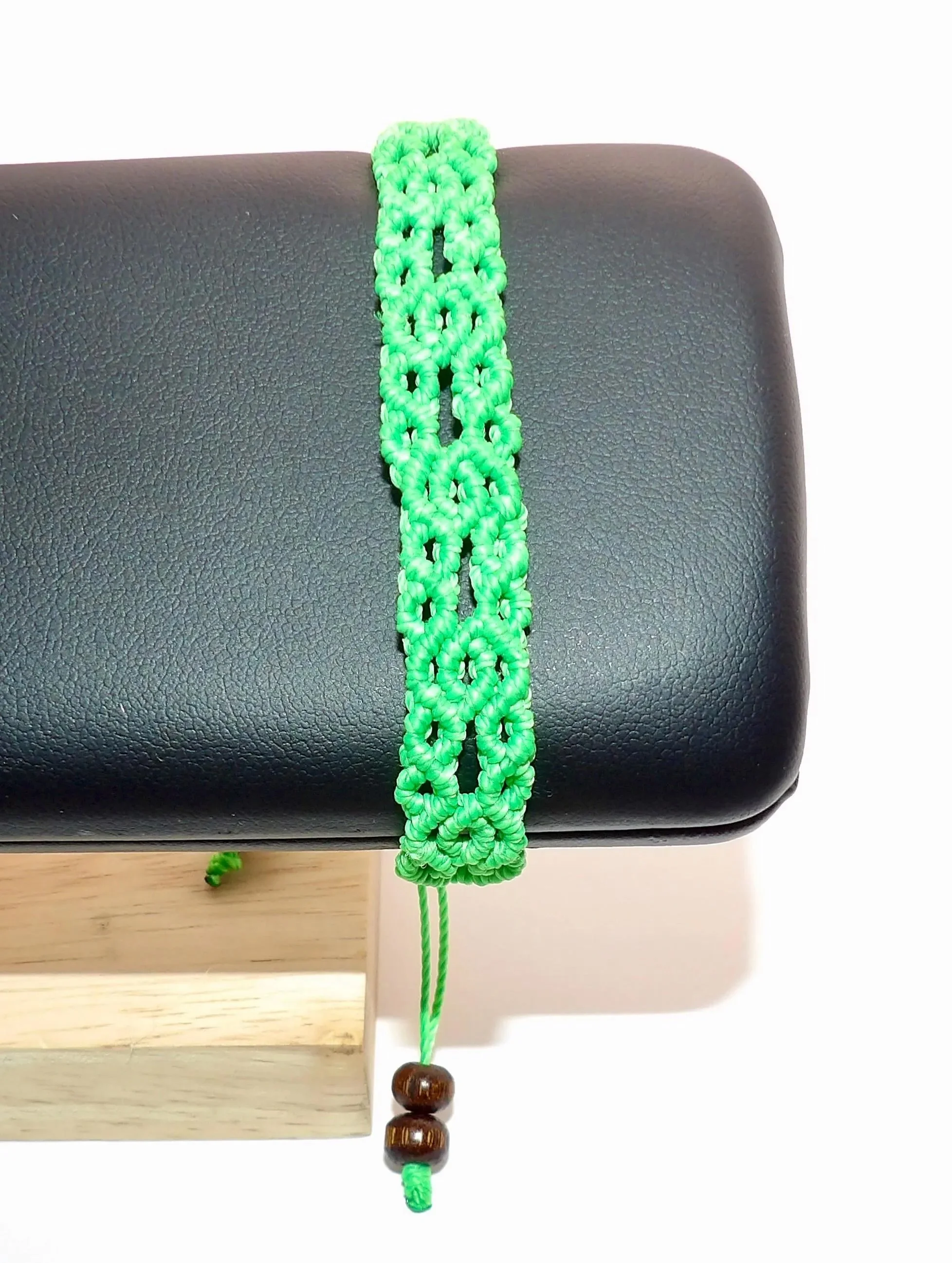 unisex infinity macramé bracelet available in custom colors with hand-knotted architectural details and natural wood.