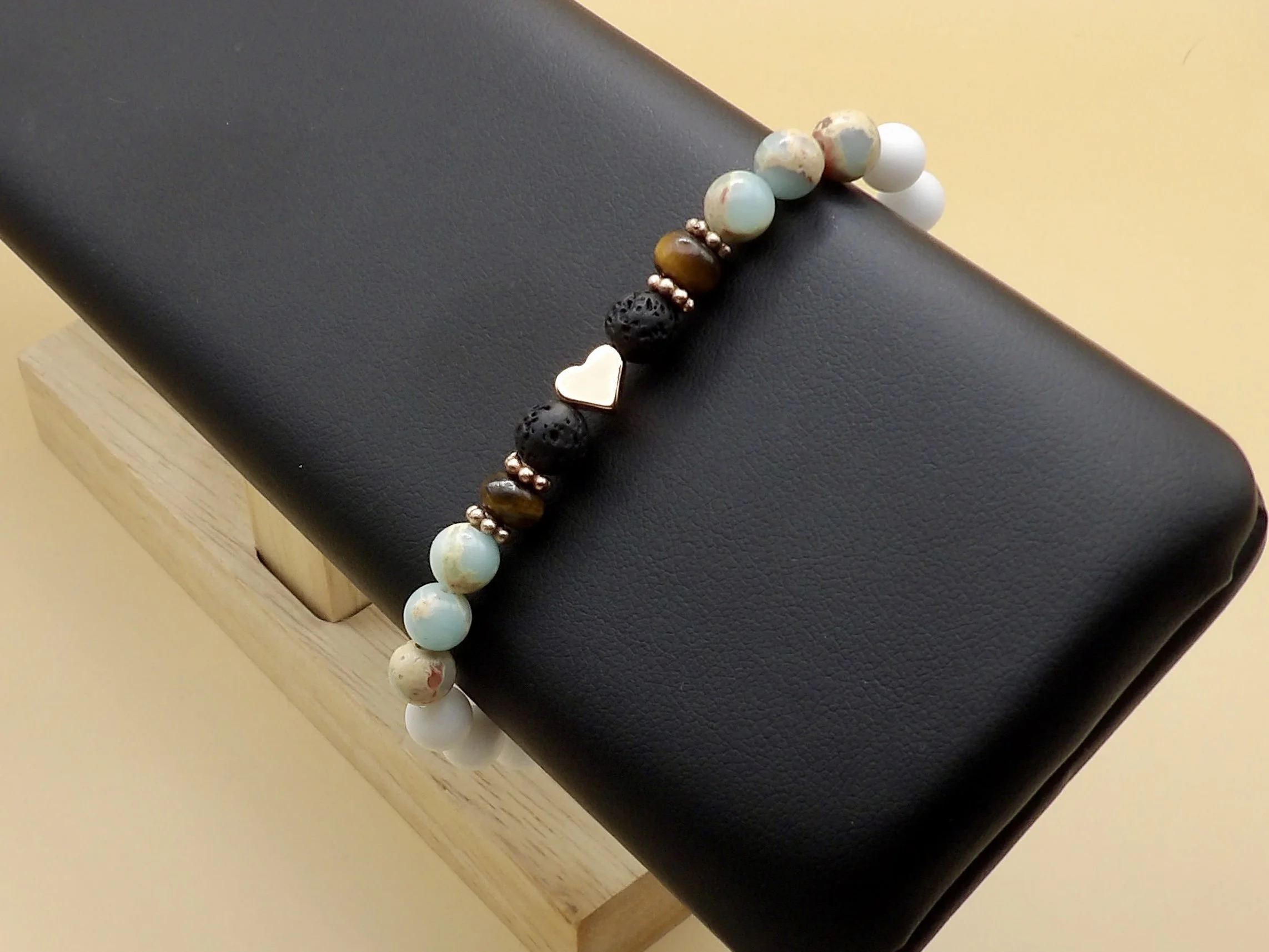 woman wearing the 6mm mixed gemstone bracelet with rose gold heart showing its unique boho luxe style and comfortable fit.