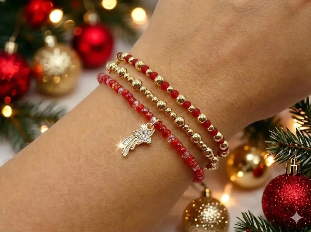 a luxurious festive stacking set showing three coordinated red and gold bracelets balancing rich glass textures and high-shine gold plating.