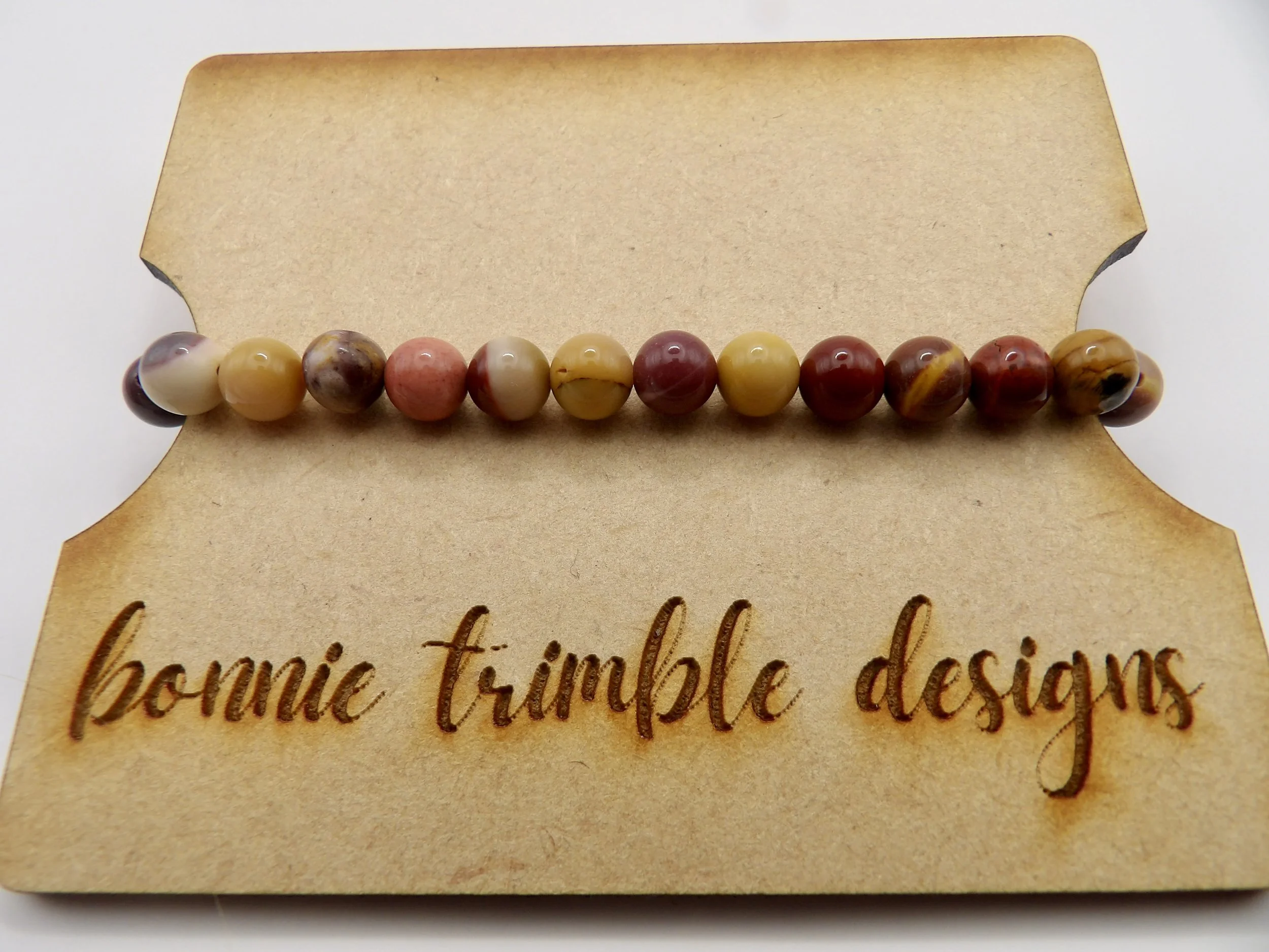 the mookaite jasper bracelet shown stacked with gold heishi bracelets for a warm, luxurious look.