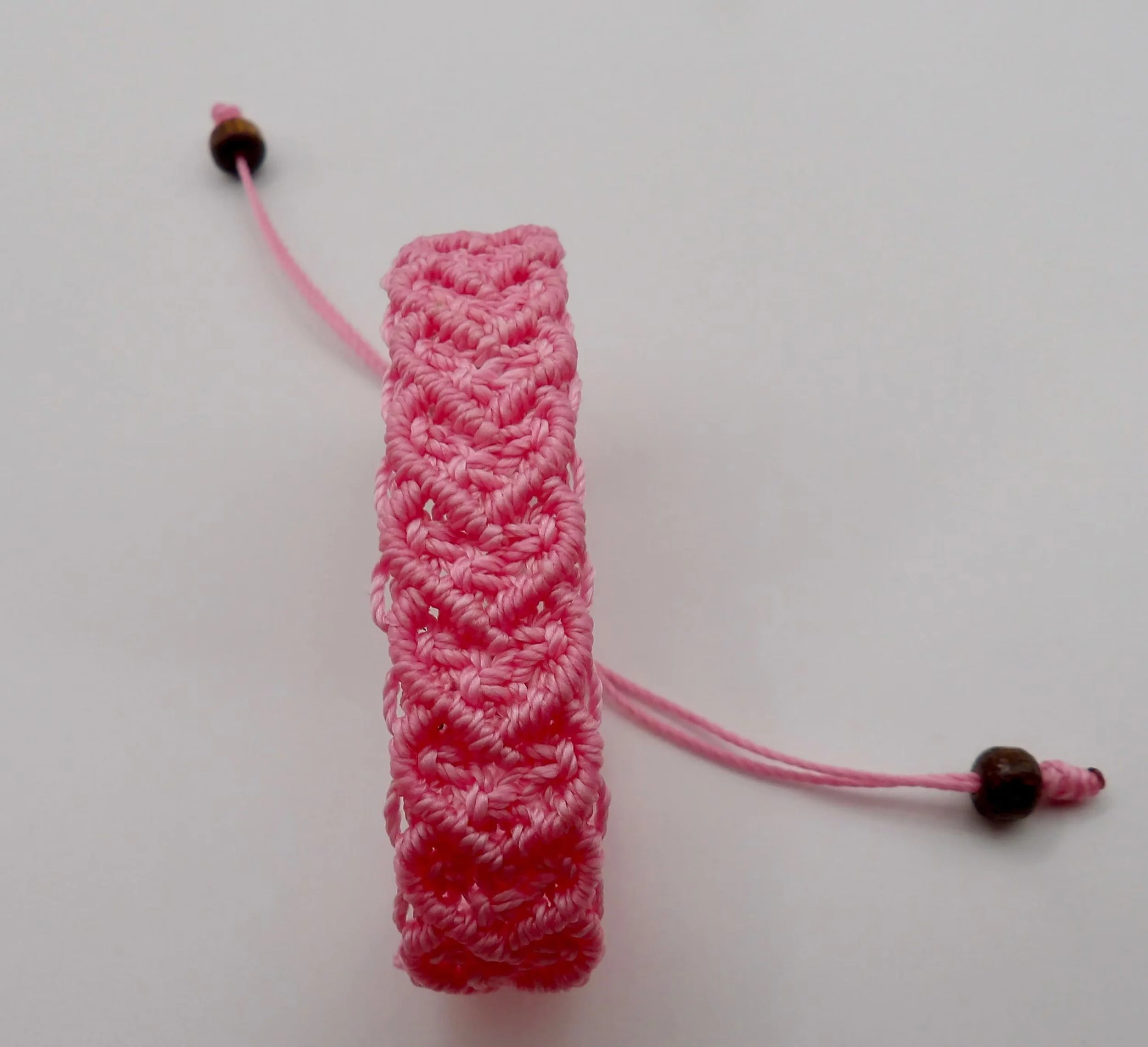 close-up of the intricate textile work on the romantic bohemian heart cuff, highlighting the precision of the woven knots.