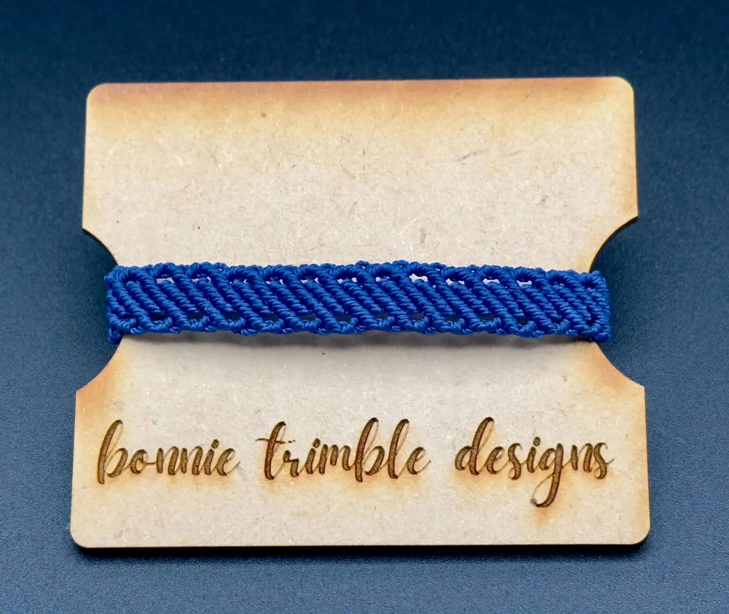 handmade royal blue micro macrame bracelet featuring a multi-row design that looks like a stack.