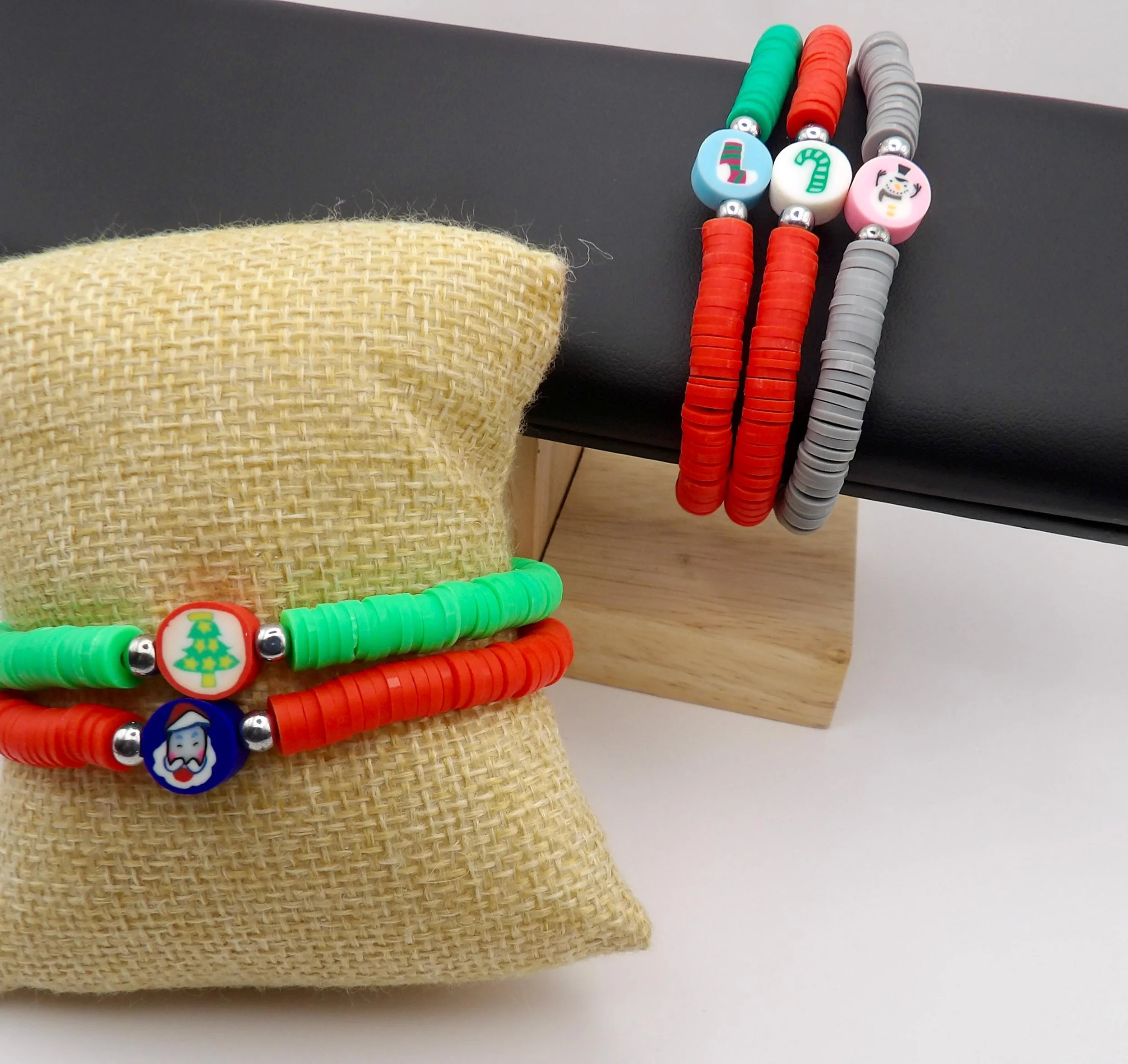 handcrafted holiday jewelry featuring vibrant polymer clay heishi beads and a central christmas-inspired focal bead.