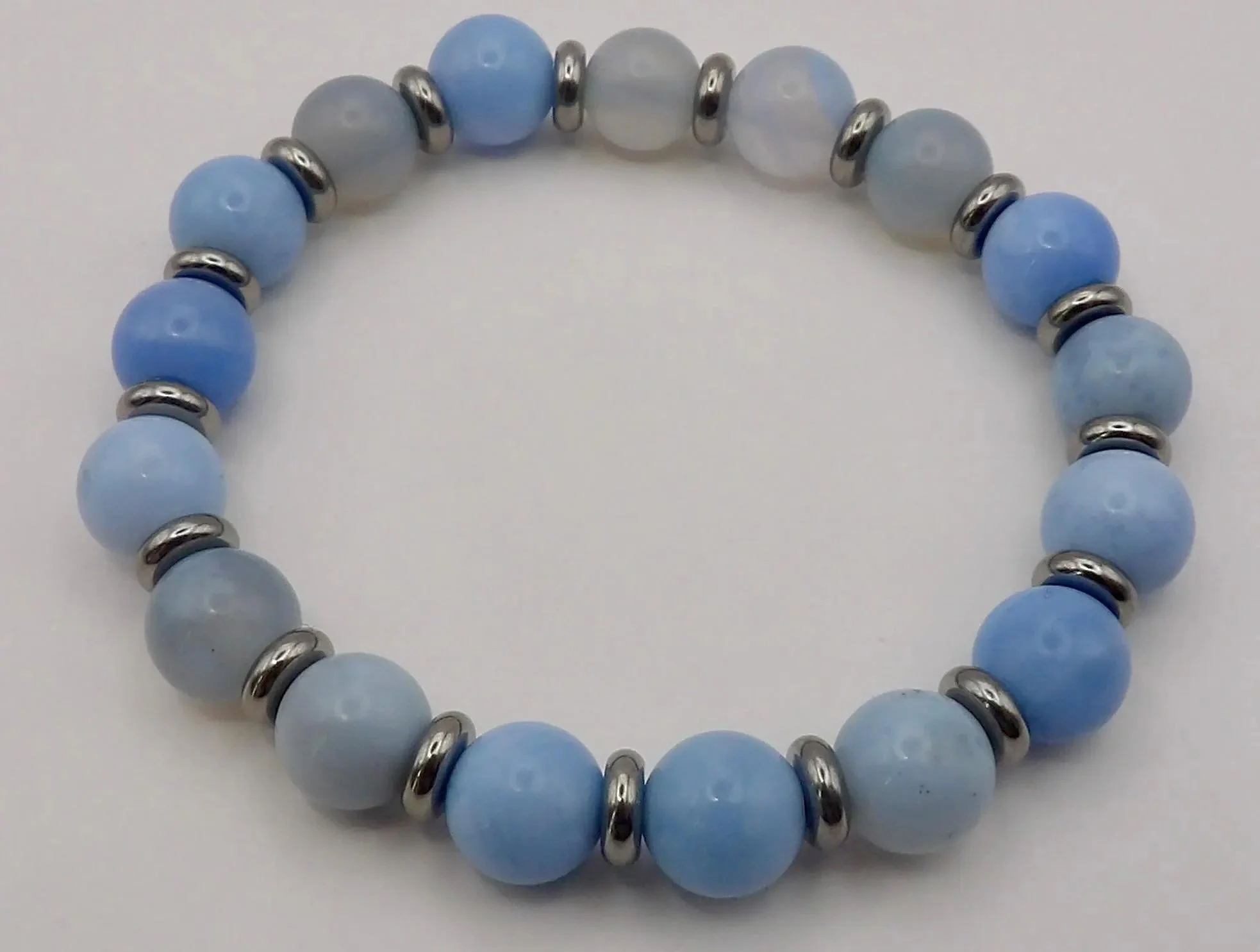 close-up of the coastal calm bracelet highlighting the smooth, premium polish of the 3mm agate beads and the crisp symmetry of the platinum accents.