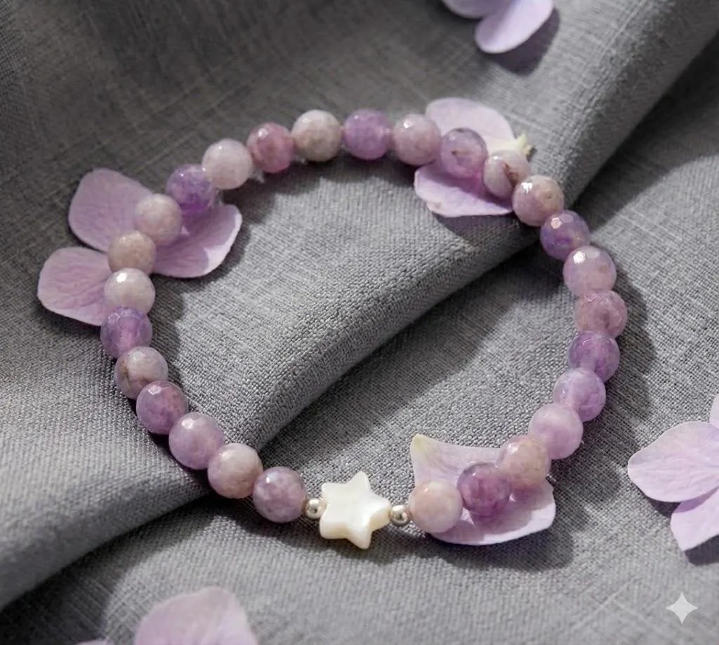 Lavender beaded bracelet with silver clasp on a white marble surface. The handmade purple jewelry features polished amethyst stones and a minimalist design.